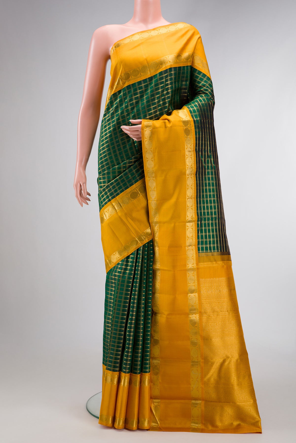 Pure Silk Pure Zari Bottle Green Dual Tone Kanjivaram Saree with Zari Brocade on the body and Zari Border.  displayed on a mannequin