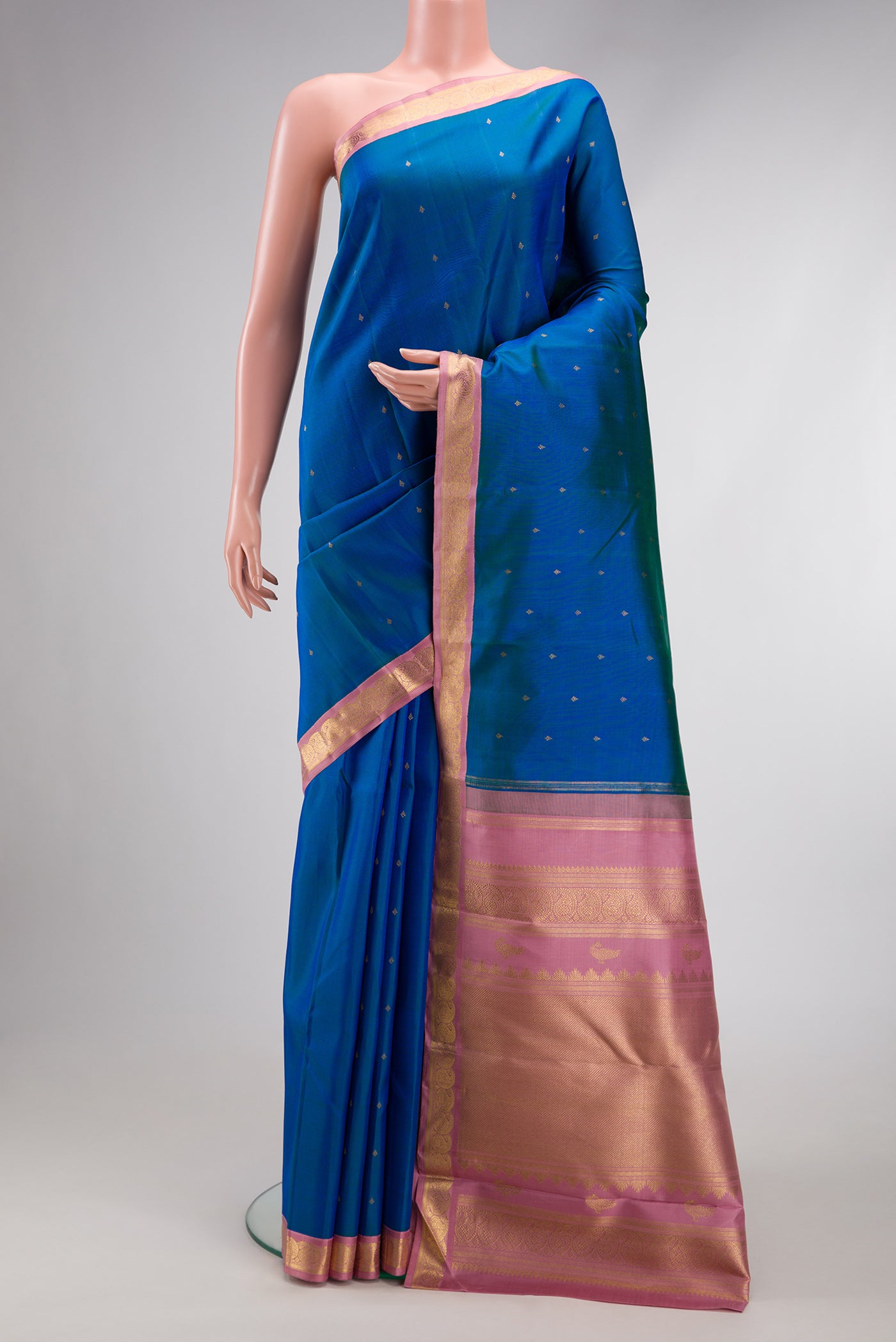 Pure Silk Pure Zari Peacock Blue Dual Tone Kanjivaram Saree with Zari Butta on the body and Zari Border.  displayed on a mannequin