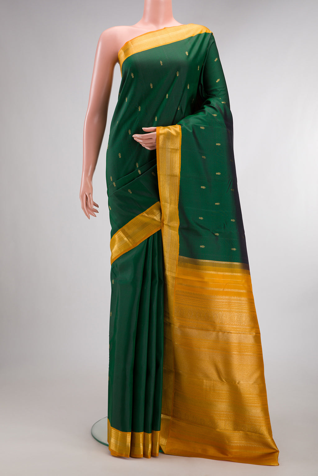 Pure Silk Pure Zari Bottle Green Kanjivaram Saree with Zari Butta on the body and Zari Border.  displayed on a mannequin