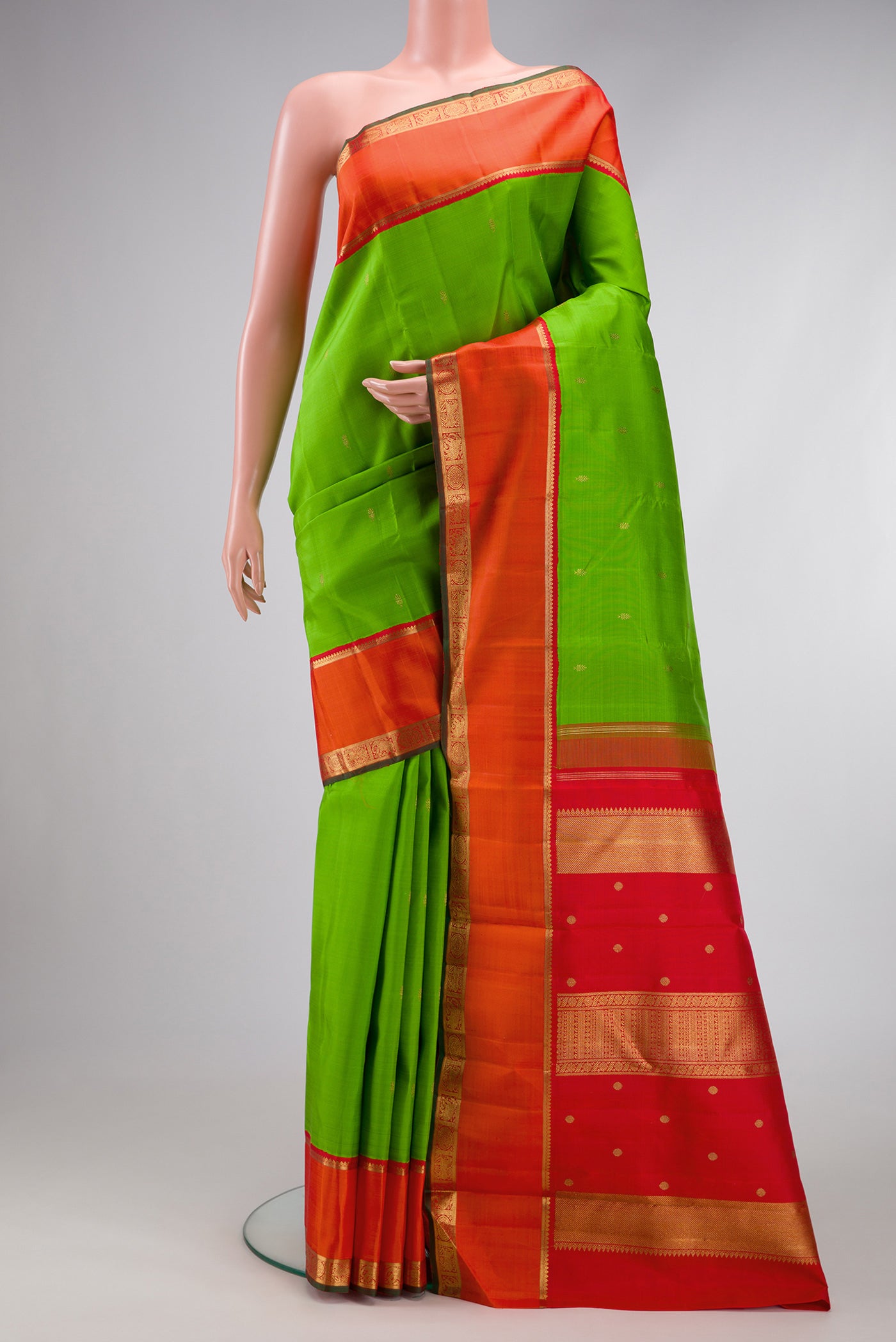 Pure Silk Pure Zari Parrot Green Dual Tone Kanjivaram Saree with Zari Butta on the body and Zari Border.  displayed on a mannequin