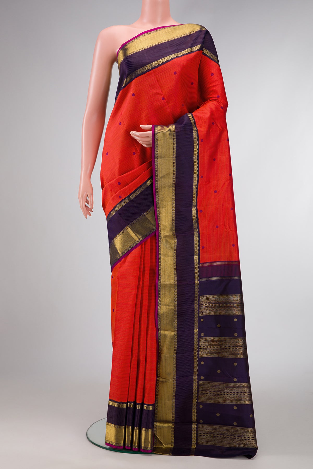 Pure Silk Pure Zari Orange Dual Tone Kanjivaram Saree with Thread Butta on the body and Zari Border.  displayed on a mannequin