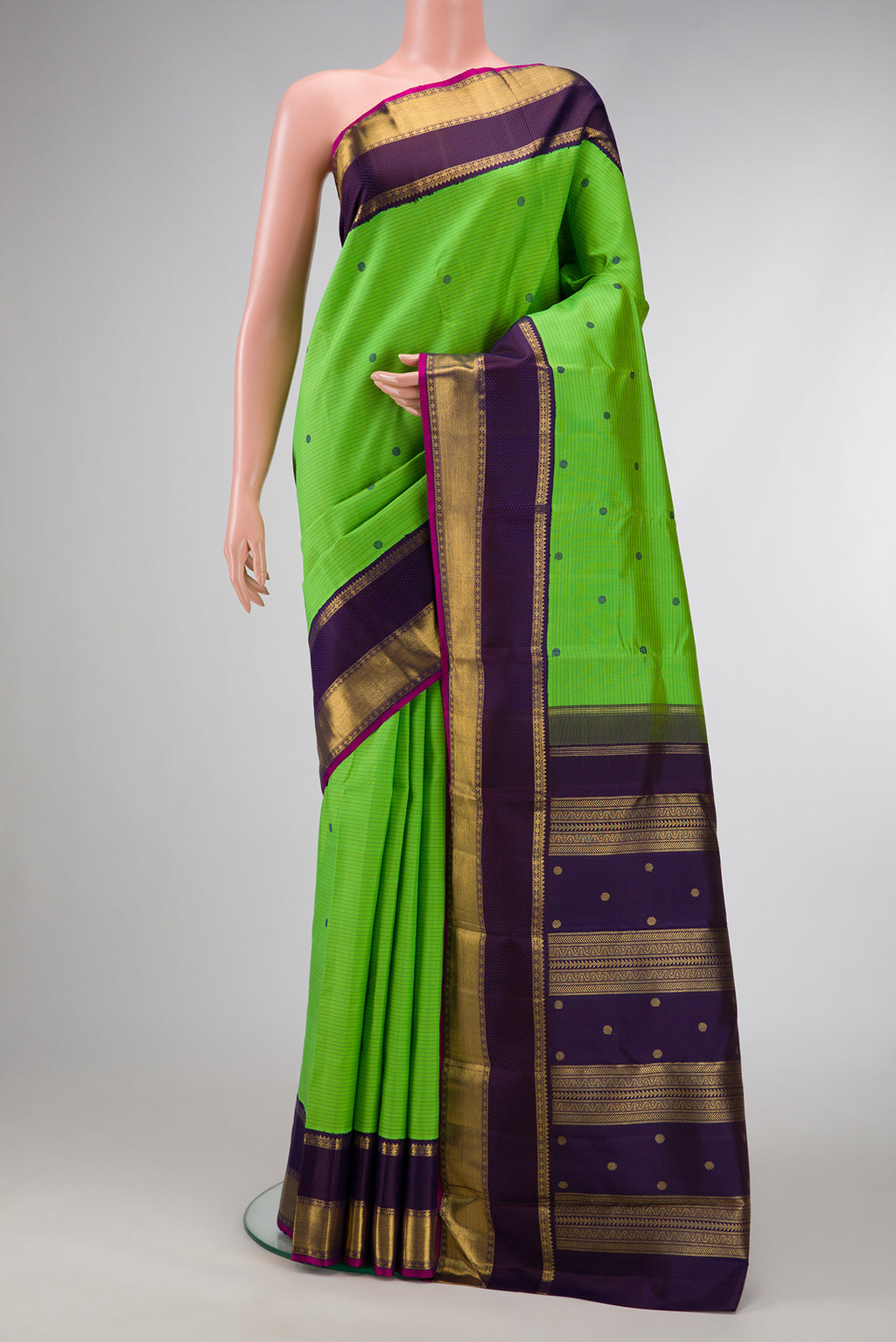 Pure Silk Pure Zari Parrot Green Dual Tone Kanjivaram Saree with Stripes on the body and Zari And Thread Border.  displayed on a mannequin