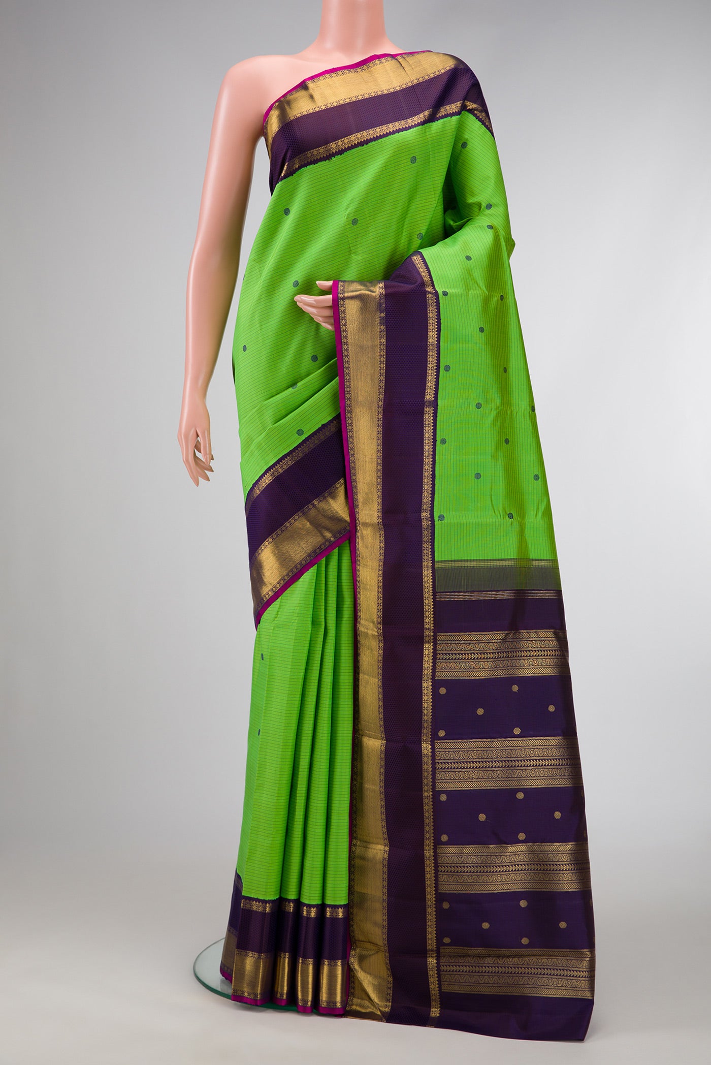 Pure Silk Pure Zari Parrot Green Dual Tone Kanjivaram Saree with Stripes on the body and Zari And Thread Border.  displayed on a mannequin