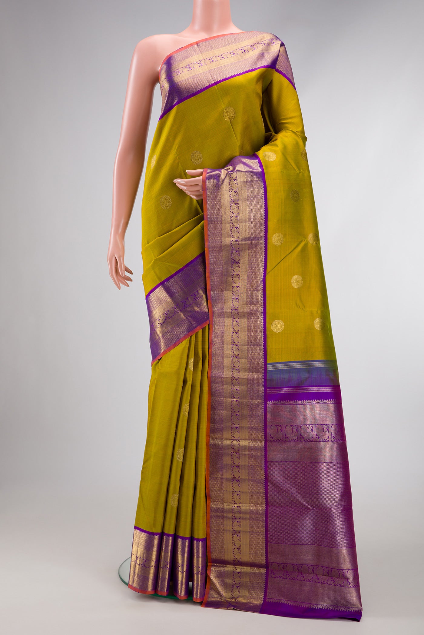 Pure Silk Pure Zari Mehandi Green Kanjivaram Saree with Zari Butta on the body and Zari Border.  displayed on a mannequin