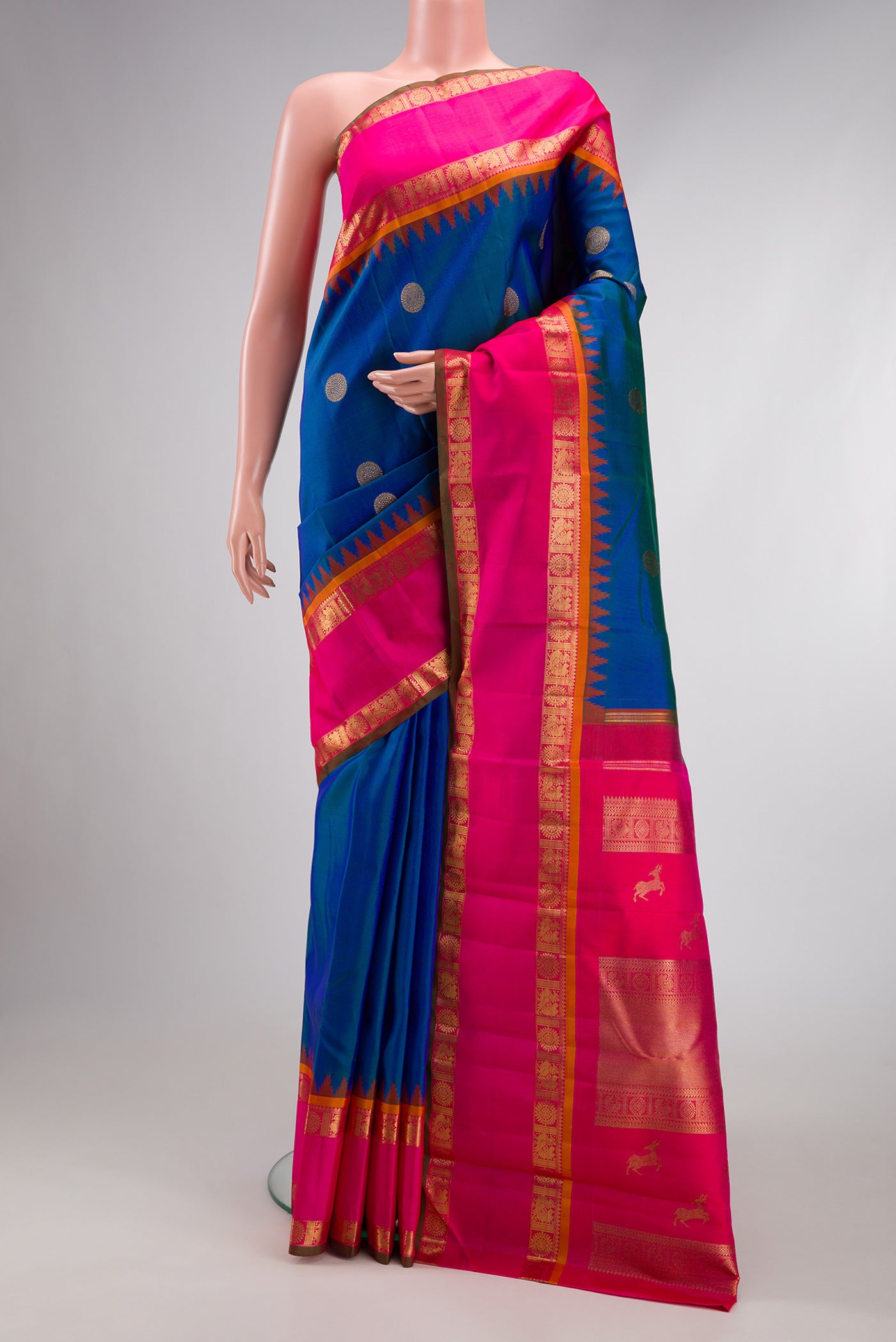 Pure Silk Pure Zari Peacock Blue Kanjivaram Saree with Zari Butta on the body and Zari Border.  displayed on a mannequin