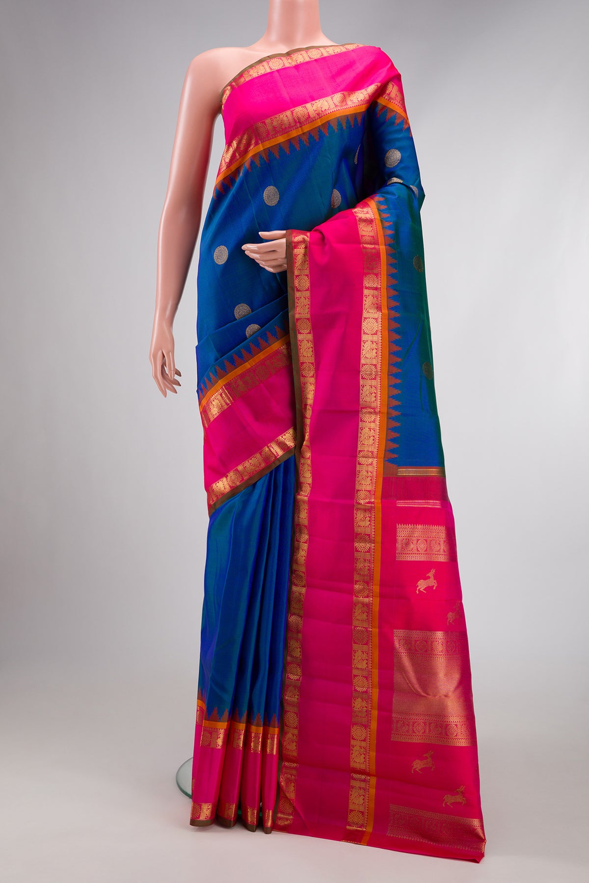 Pure Silk Pure Zari Peacock Blue Kanjivaram Saree with Zari Butta on the body and Zari Border.  displayed on a mannequin