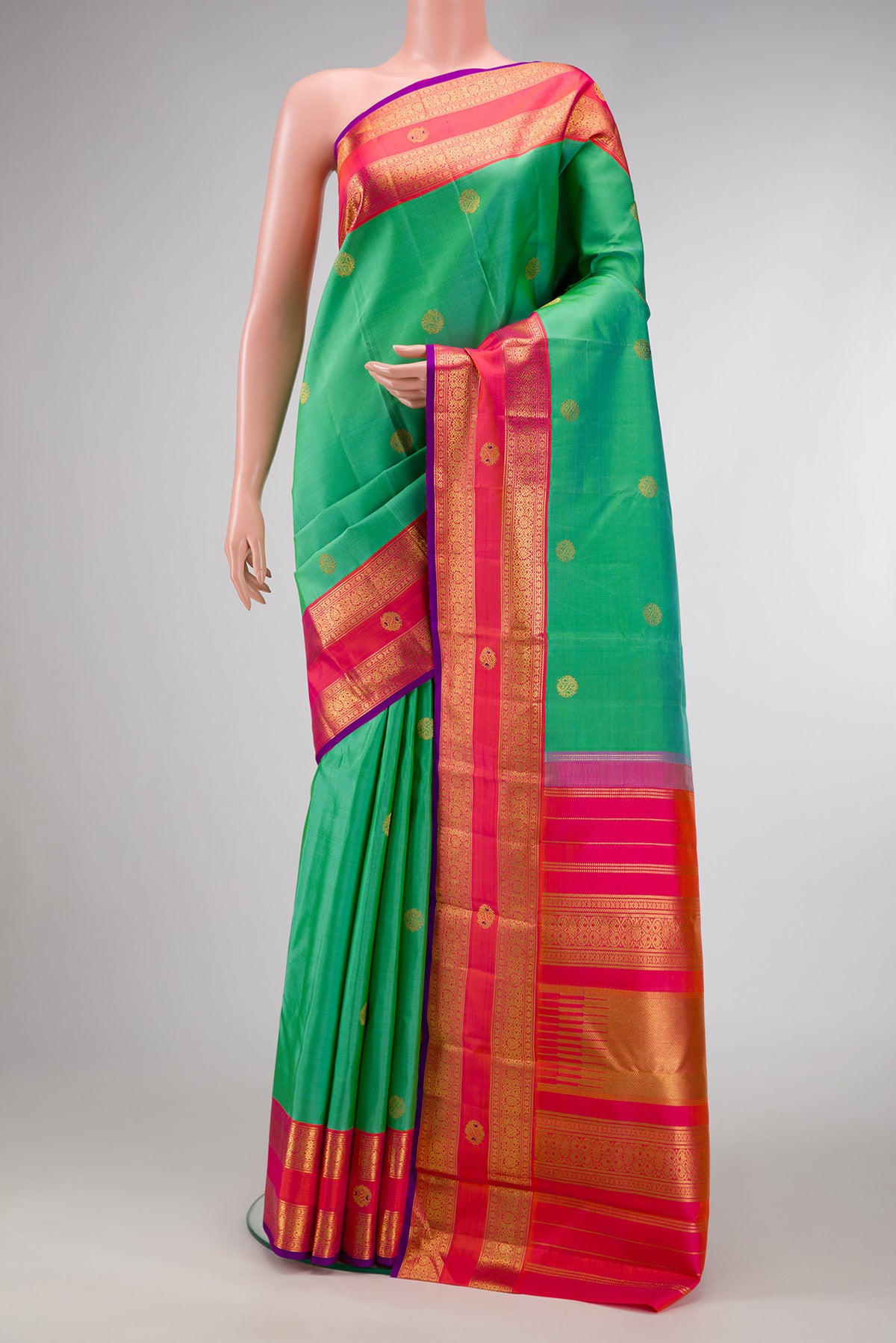 Pure Silk Pure Zari Sea Green Dual Tone Kanjivaram Saree with Zari Butta on the body and Fancy Border.  displayed on a mannequin