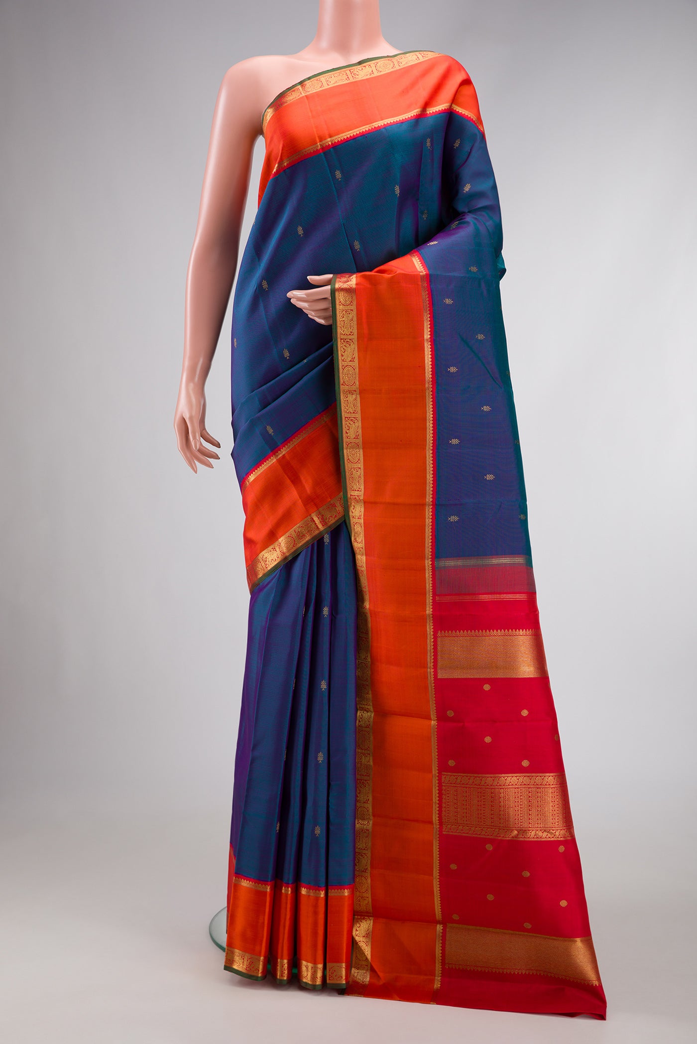 Pure Silk Pure Zari Peacock Blue Dual Tone Kanjivaram Saree with Zari Butta on the body and Zari Border.  displayed on a mannequin