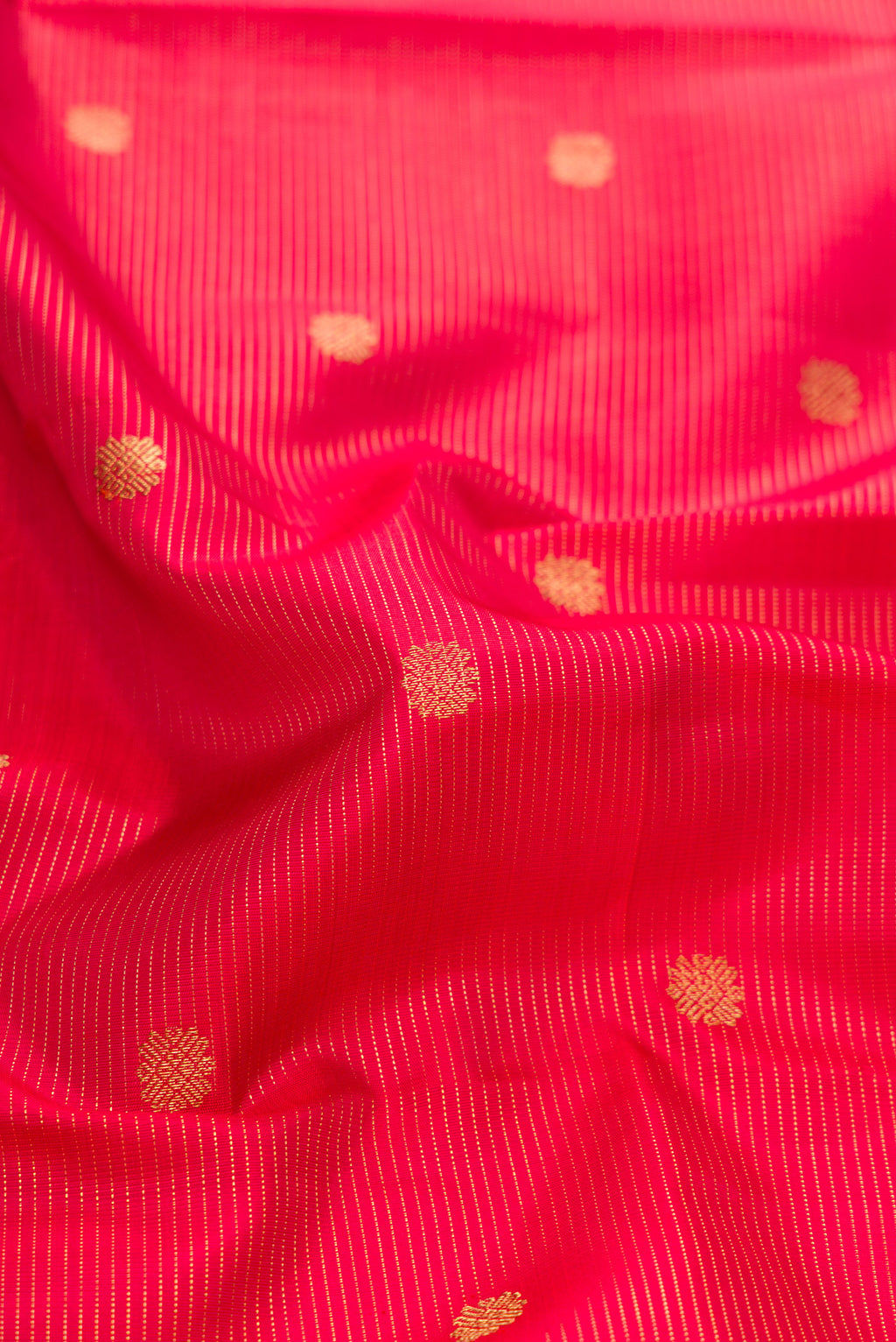 Close up of Pure Silk Pure Zari Red Dual Tone Kanjivaram Saree with Stripes on the body and Zari Border.  displaying folds