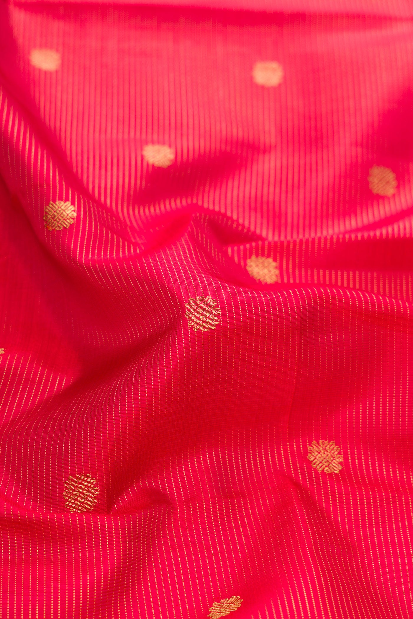 Close up of Pure Silk Pure Zari Red Dual Tone Kanjivaram Saree with Stripes on the body and Zari Border.  displaying folds