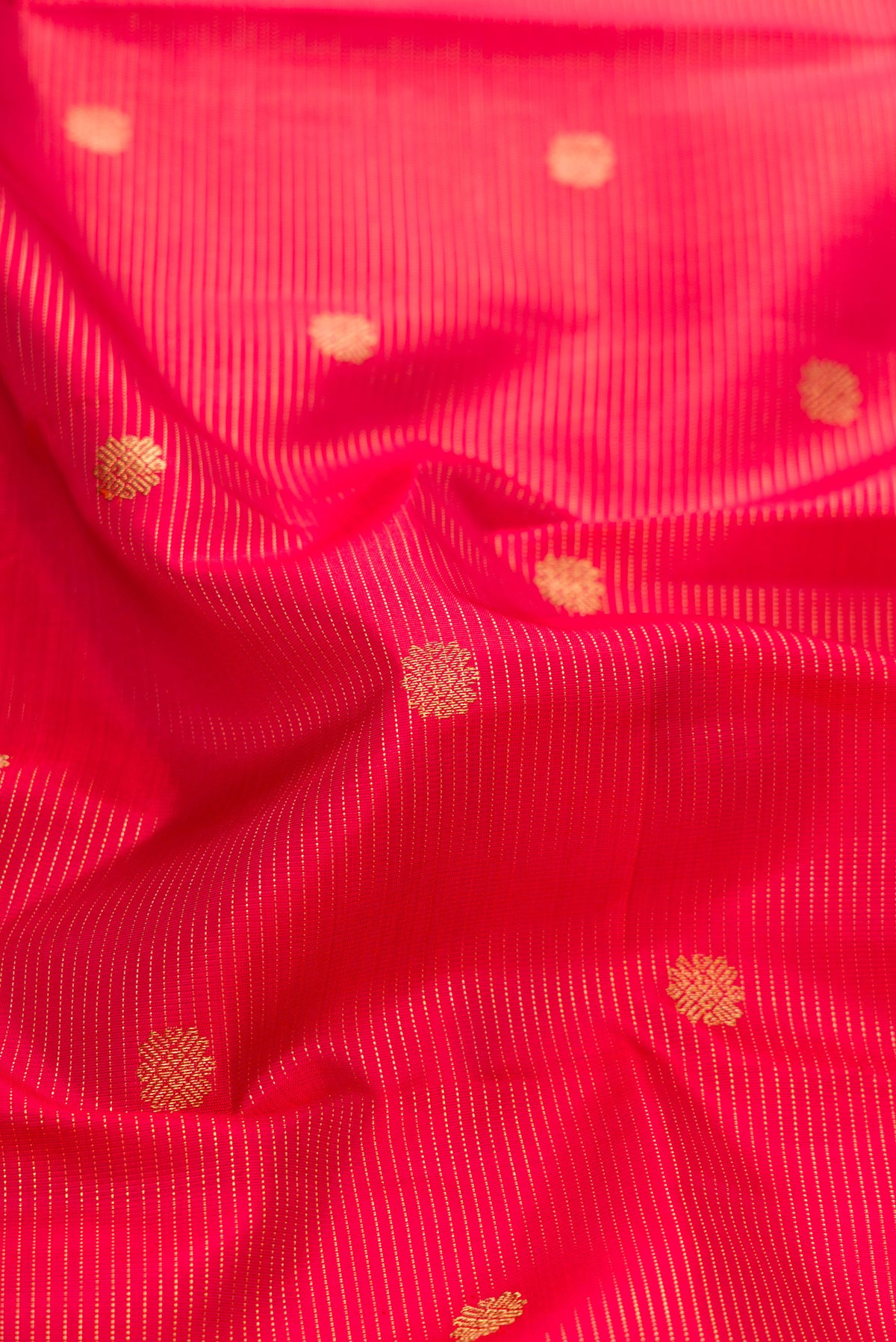 Close up of Pure Silk Pure Zari Red Dual Tone Kanjivaram Saree with Stripes on the body and Zari Border.  displaying folds