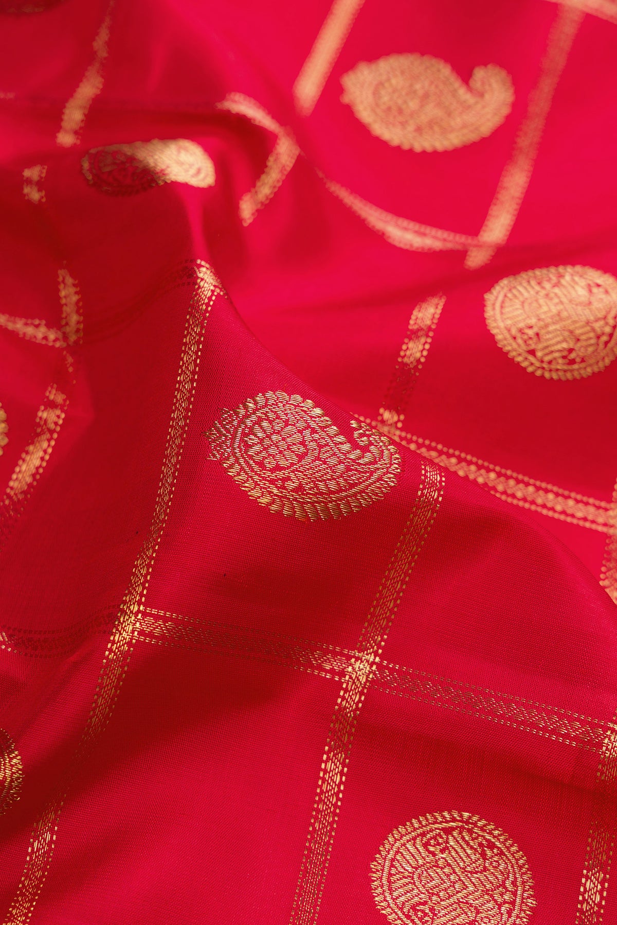 Close up of Pure Silk Pure Zari Deep Red Kanjivaram Saree with Checked design on the body and Zari Border.  displaying folds