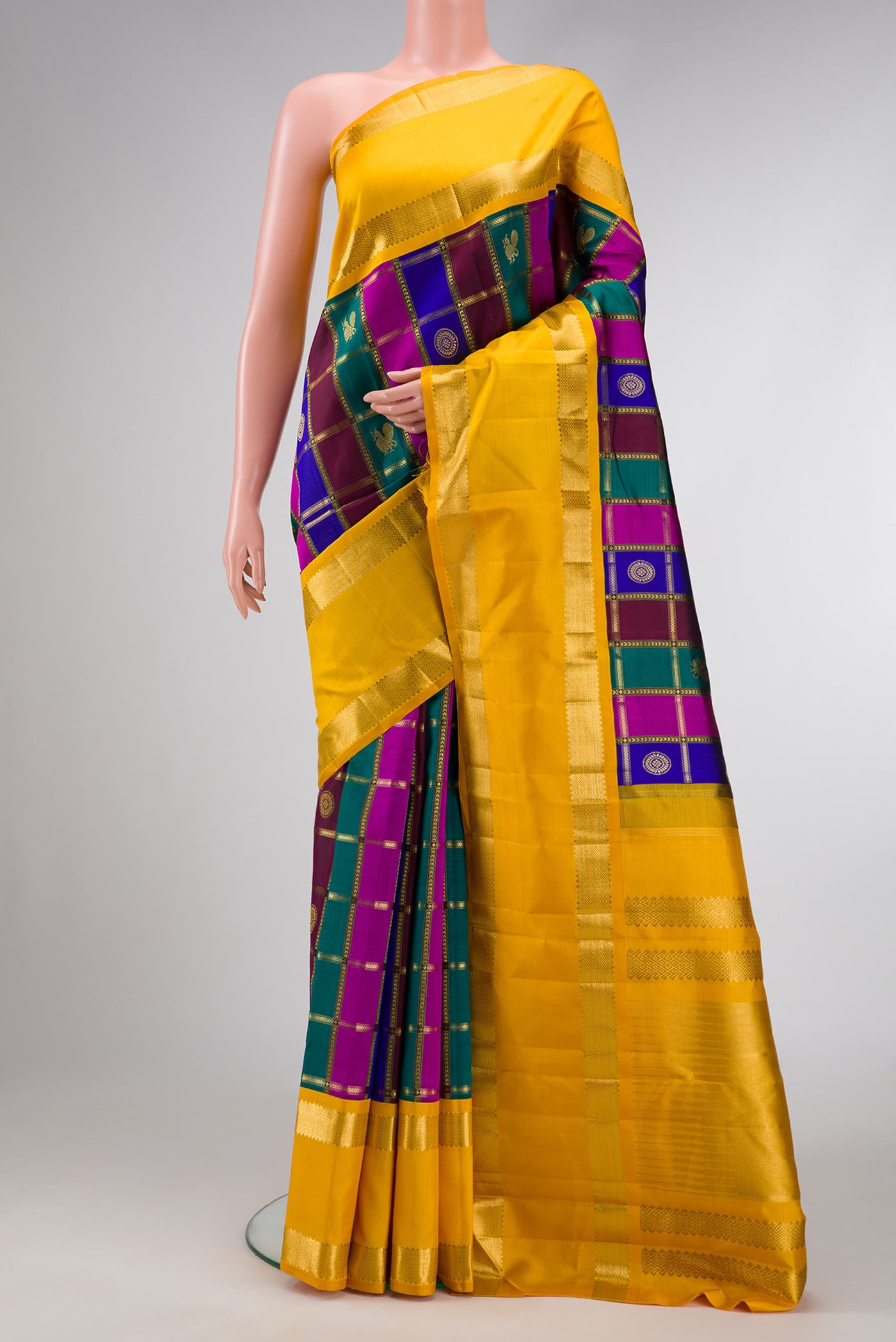 Pure Silk Pure Zari Green, Royal Blue and Maroon Color Kanjivaram Saree with Checked design on the body and Zari Border.  displayed on a mannequin