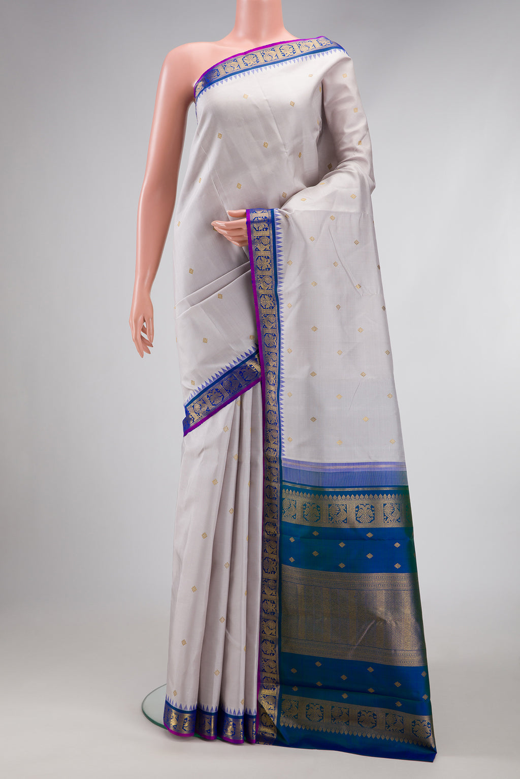Pure Silk Pure Zari Grey Kanjivaram Saree with Zari Butta on the body and Zari Border.  displayed on a mannequin