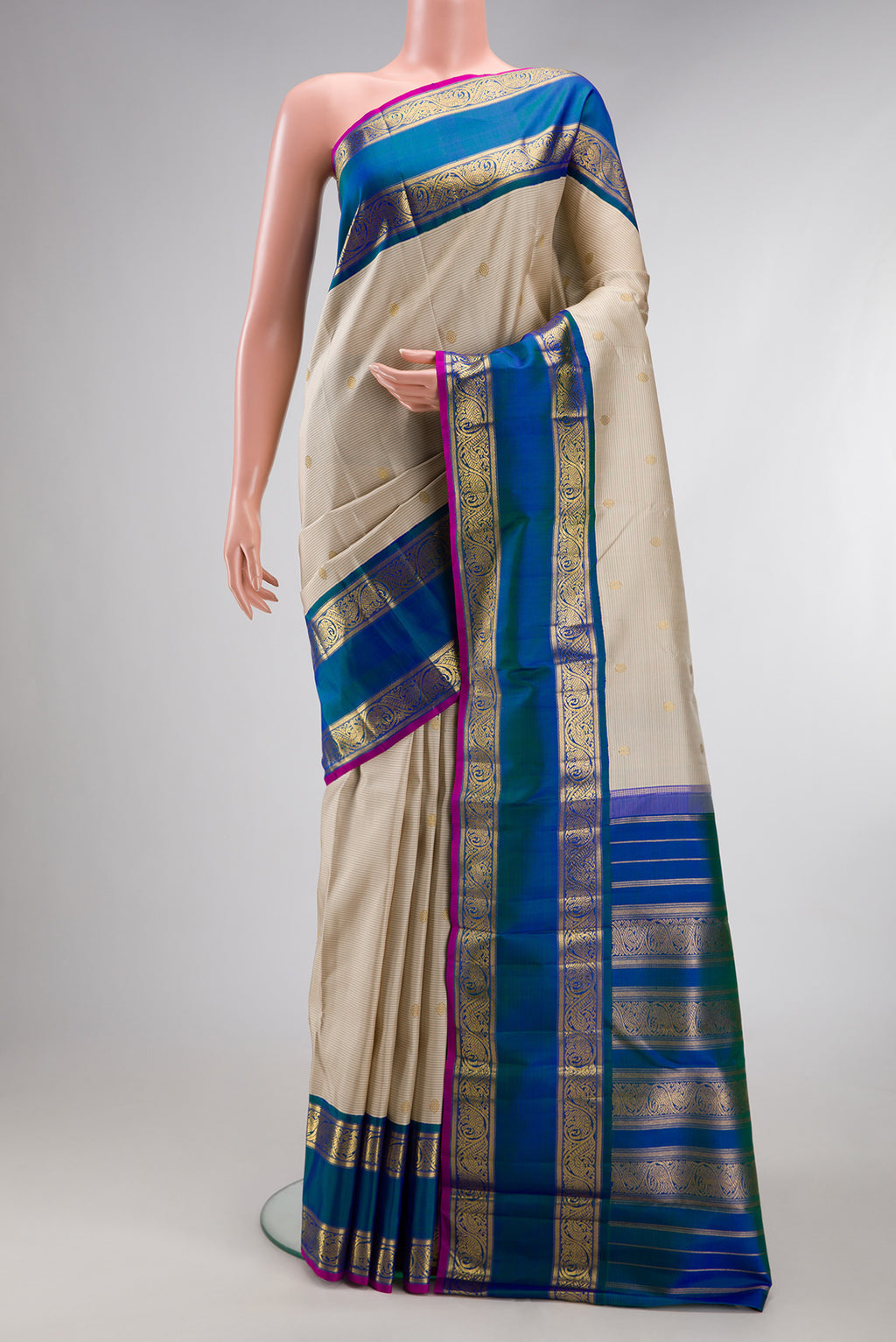 Pure Silk Pure Zari Cream Kanjivaram Saree with Zari Butta on the body and Zari Border.  displayed on a mannequin