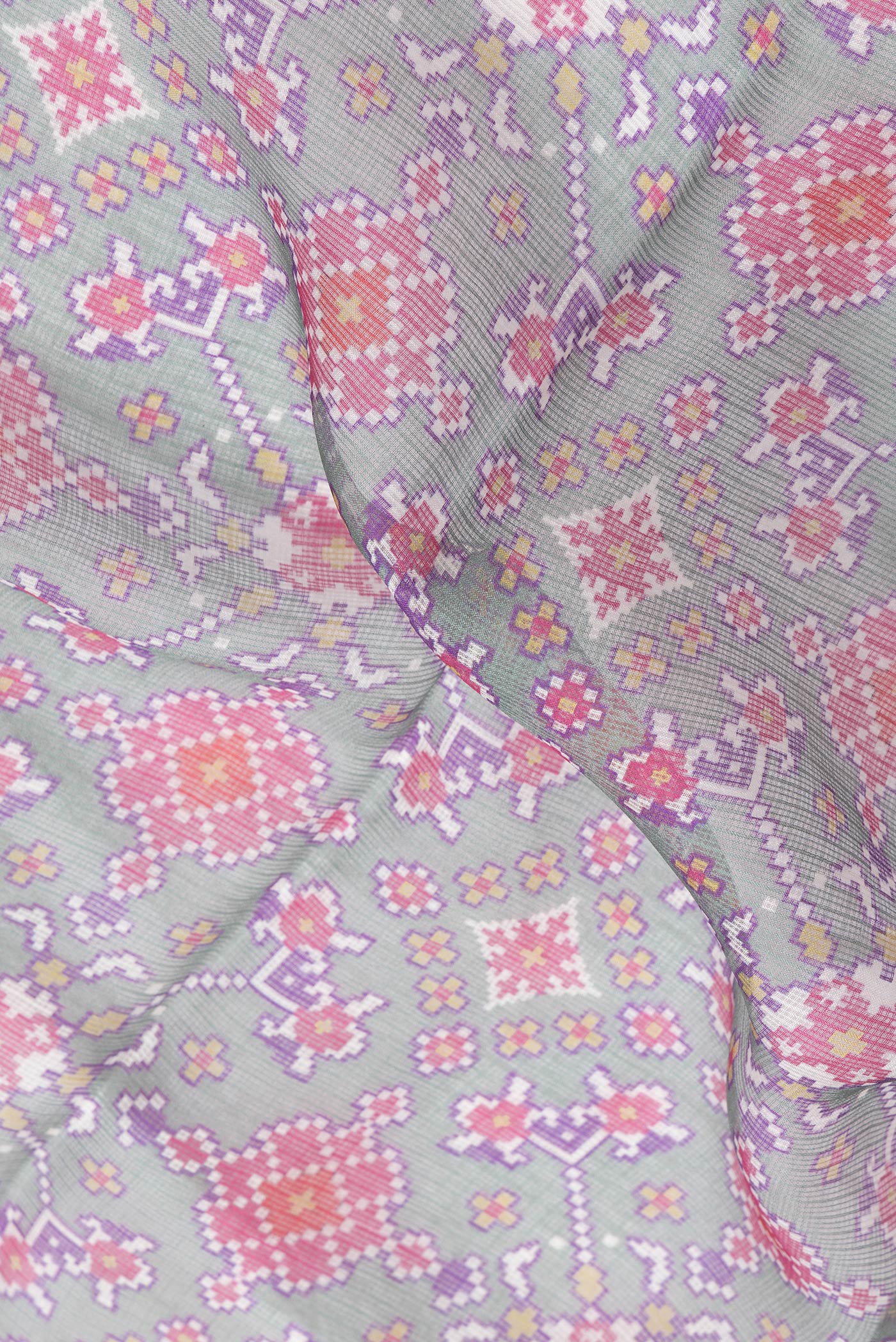 Close up of Green Dual Tone Kota Silk Saree with Printed design on the body and Zari Border.  displaying folds