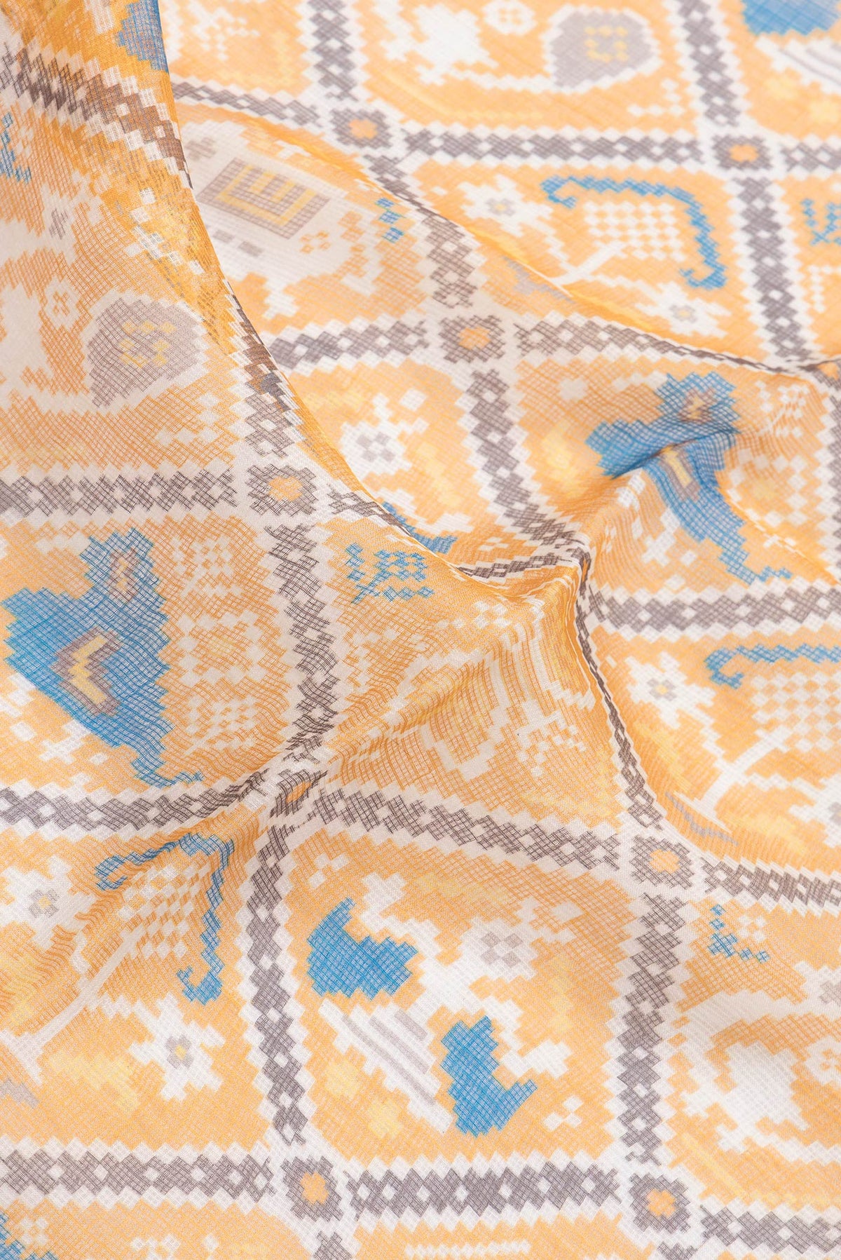 Close up of Orange Dual Tone Kota Silk Saree with Printed design on the body and Zari Border.  displaying folds