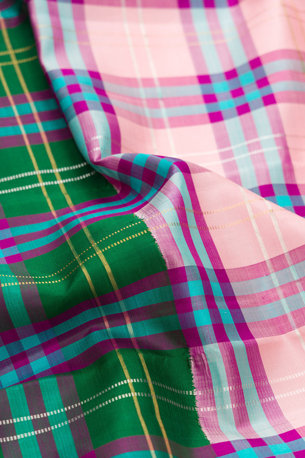 Close up of Multi Color Kanjivaram Silk Saree with Checked design on the body and Without Border.  displaying folds