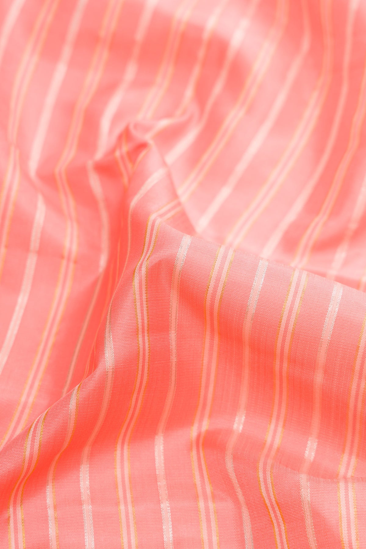 Close up of Pure Silk Pure Zari Peach Dual Tone Kanjivaram Saree with Stripes on the body and Zari Border.  displaying folds