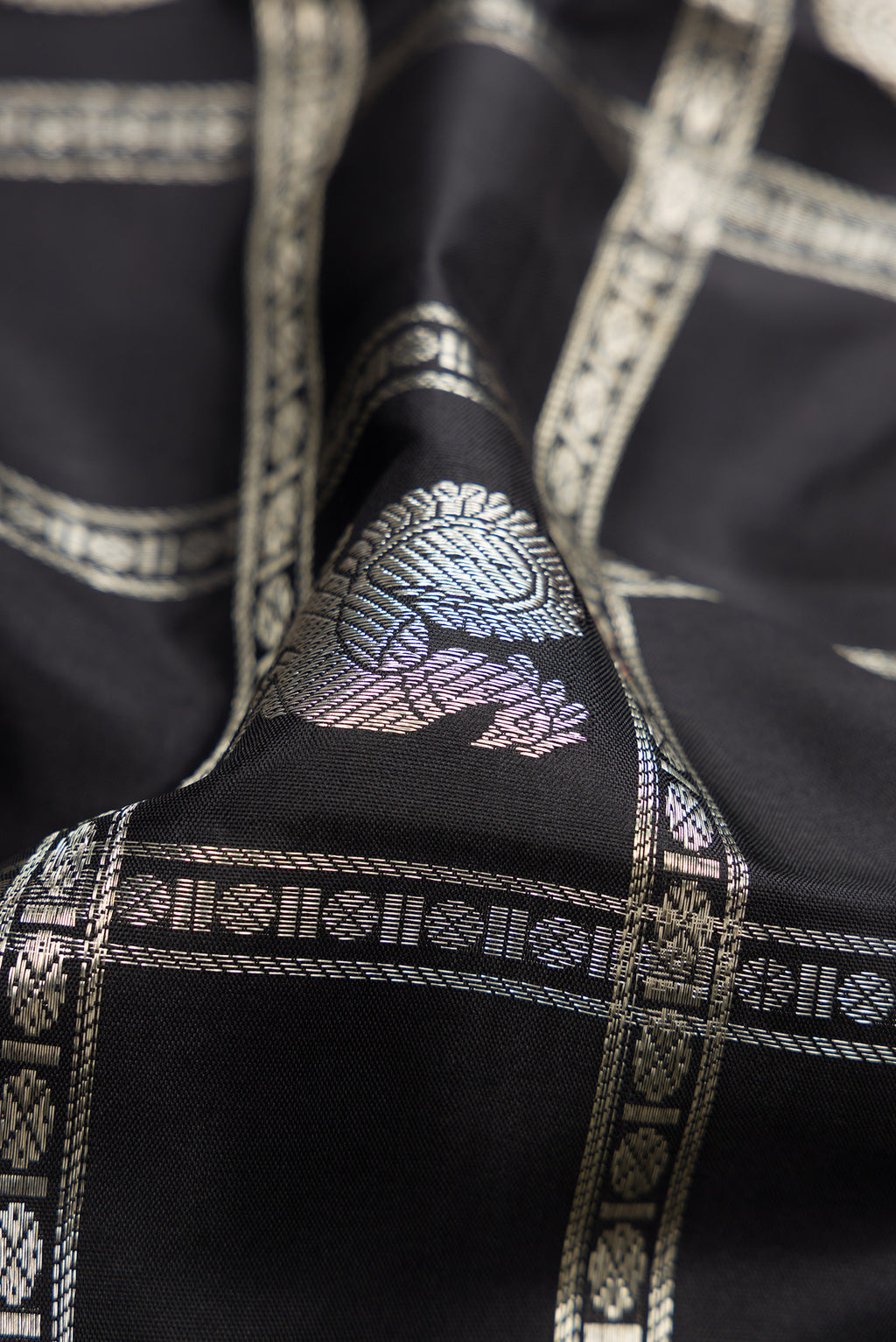 Close up of Beige and Off White Dual Tone Kanchipuram Silk Saree with Checked design on the body and Zari Border.  displaying folds