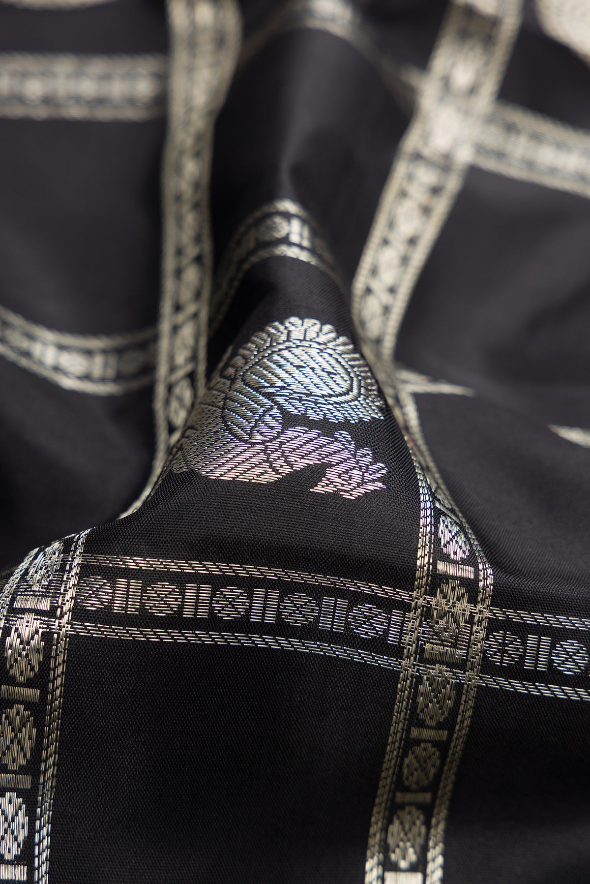 Close up of Beige and Off White Dual Tone Kanchipuram Silk Saree with Checked design on the body and Zari Border.  displaying folds
