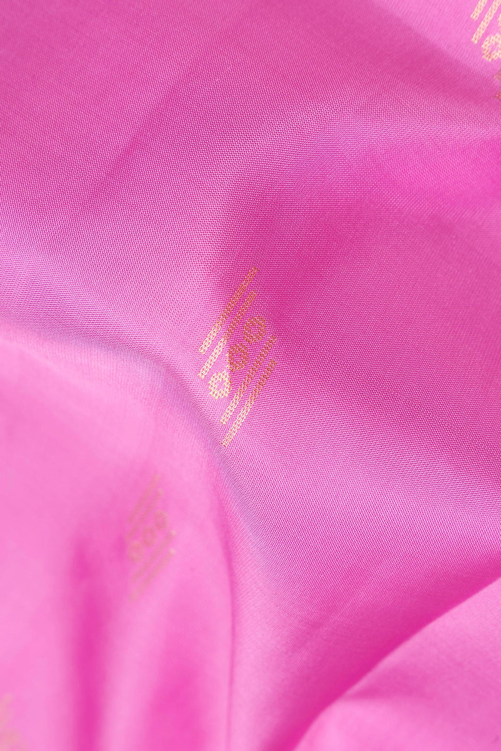 Close up of Pure Silk Rose pink Soft Saree with Zari Butta on the body and Zari Border.  displaying folds