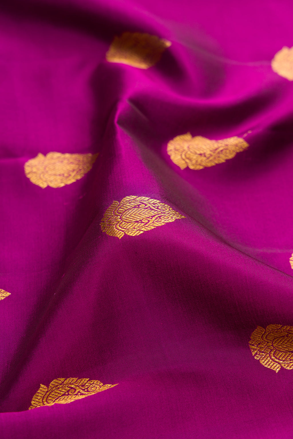 Close up of Purple Kanjivaram Silk Saree with Zari Butta on the body and Fancy Border.  displaying folds