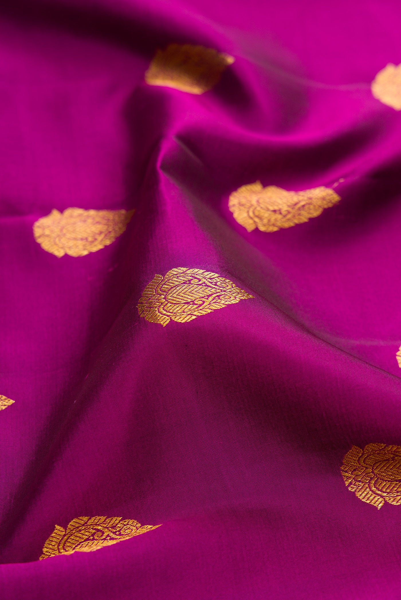 Close up of Purple Kanjivaram Silk Saree with Zari Butta on the body and Fancy Border.  displaying folds