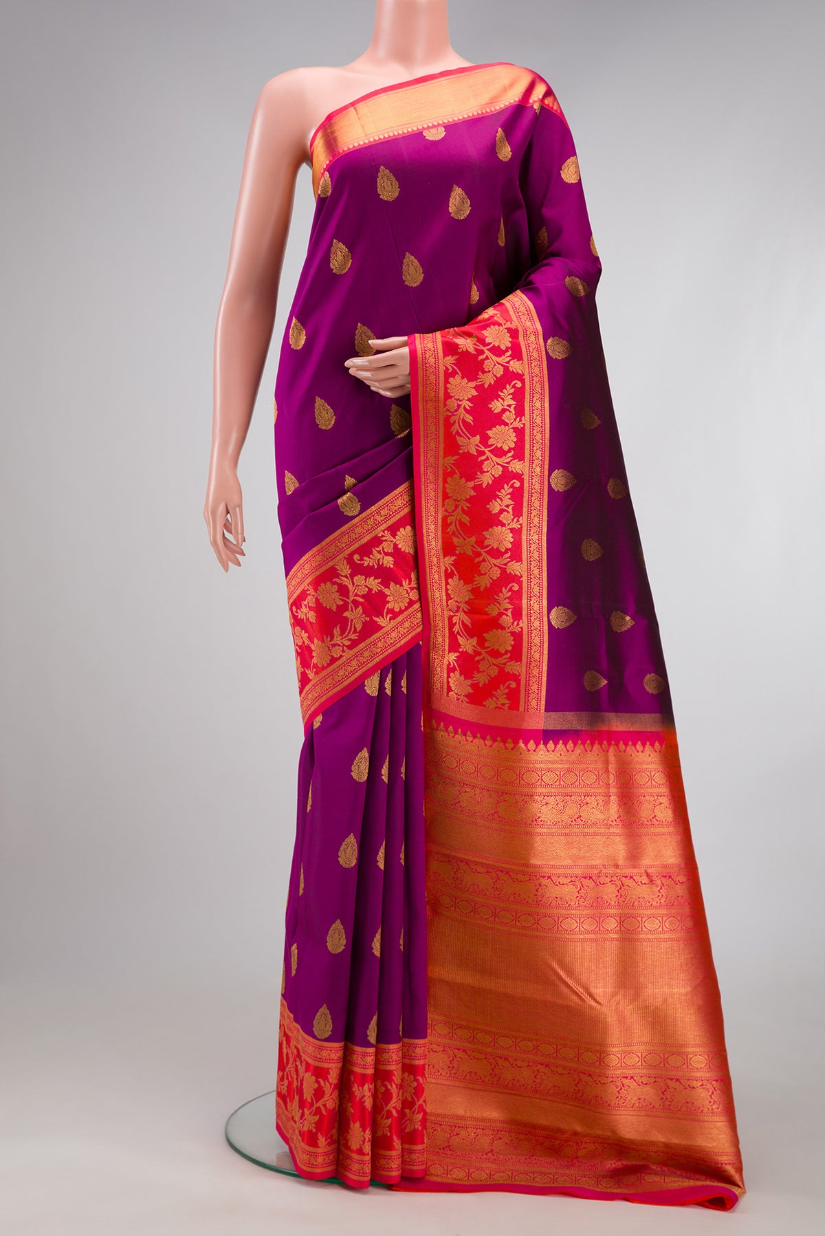 Purple Kanjivaram Silk Saree with Zari Butta on the body and Fancy Border.  displayed on a mannequin