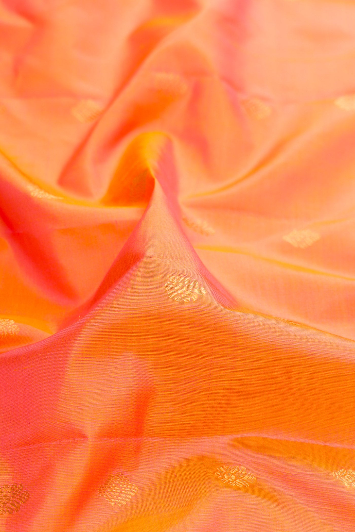 Close up of Coral Dual Tone Gadwal Silk Saree with Zari Butta on the body and Zari Border.  displaying folds