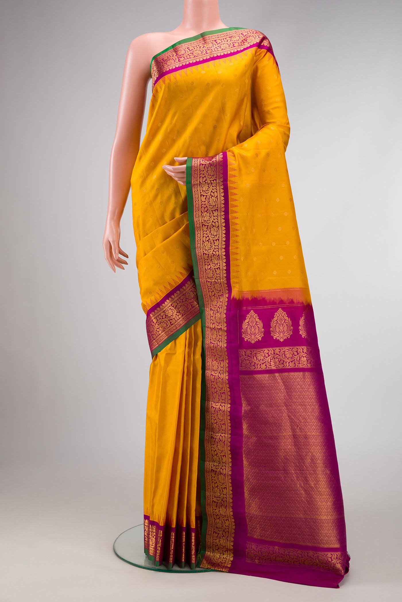 Mustard Dual Tone Gadwal Silk Saree with Zari Butta on the body and Zari Border.  displayed on a mannequin
