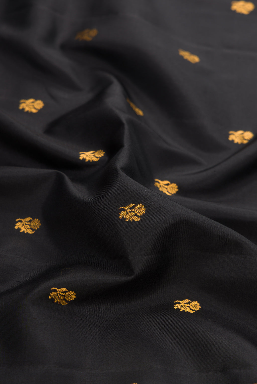 Close up of Black Dual Tone Gadwal Silk Saree with Zari Butta on the body and Zari Border.  displaying folds