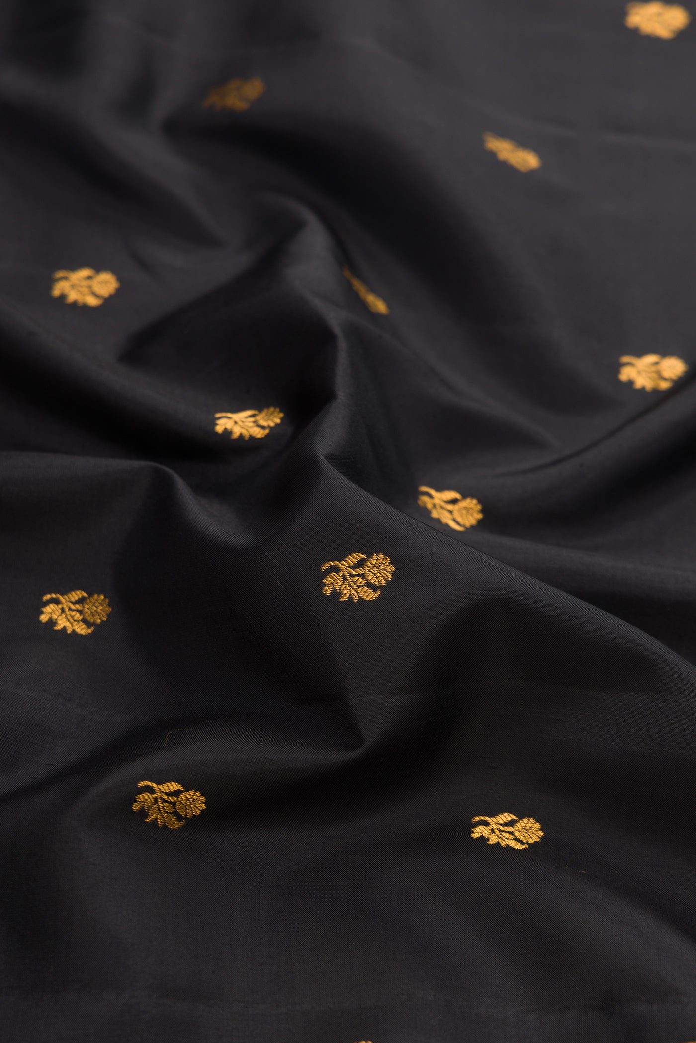 Close up of Black Dual Tone Gadwal Silk Saree with Zari Butta on the body and Zari Border.  displaying folds
