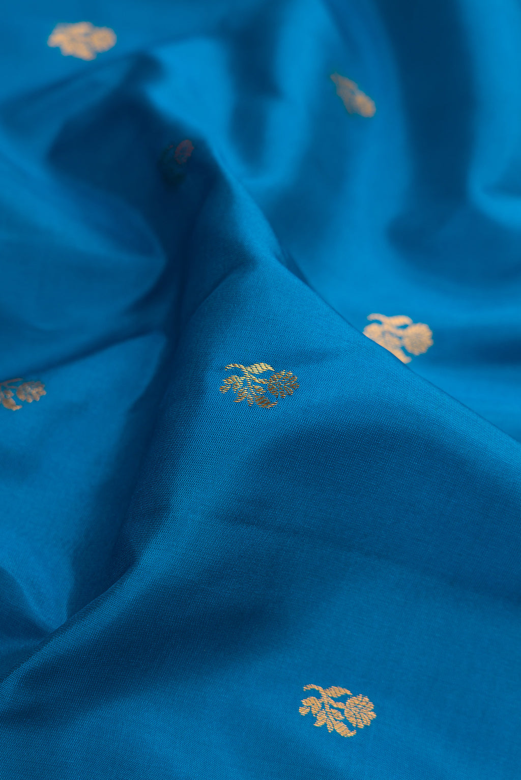 Close up of Blue Gadwal Silk Saree with Zari Butta on the body and Zari Border.  displaying folds