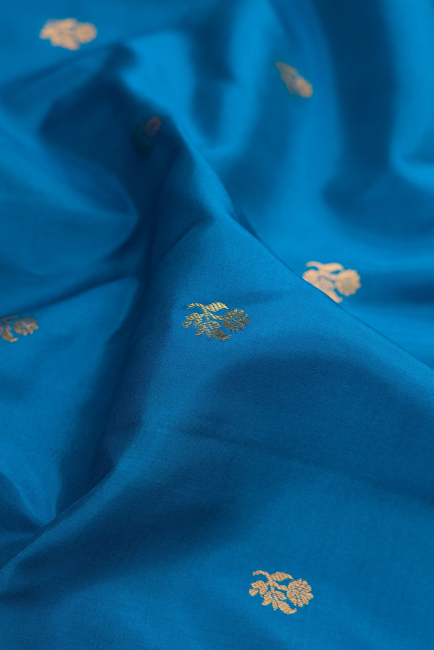 Close up of Blue Gadwal Silk Saree with Zari Butta on the body and Zari Border.  displaying folds
