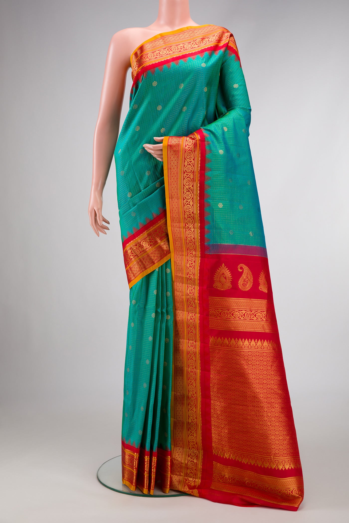 Green Dual Tone Gadwal Silk Saree with Checked design on the body and Zari Border.  displayed on a mannequin