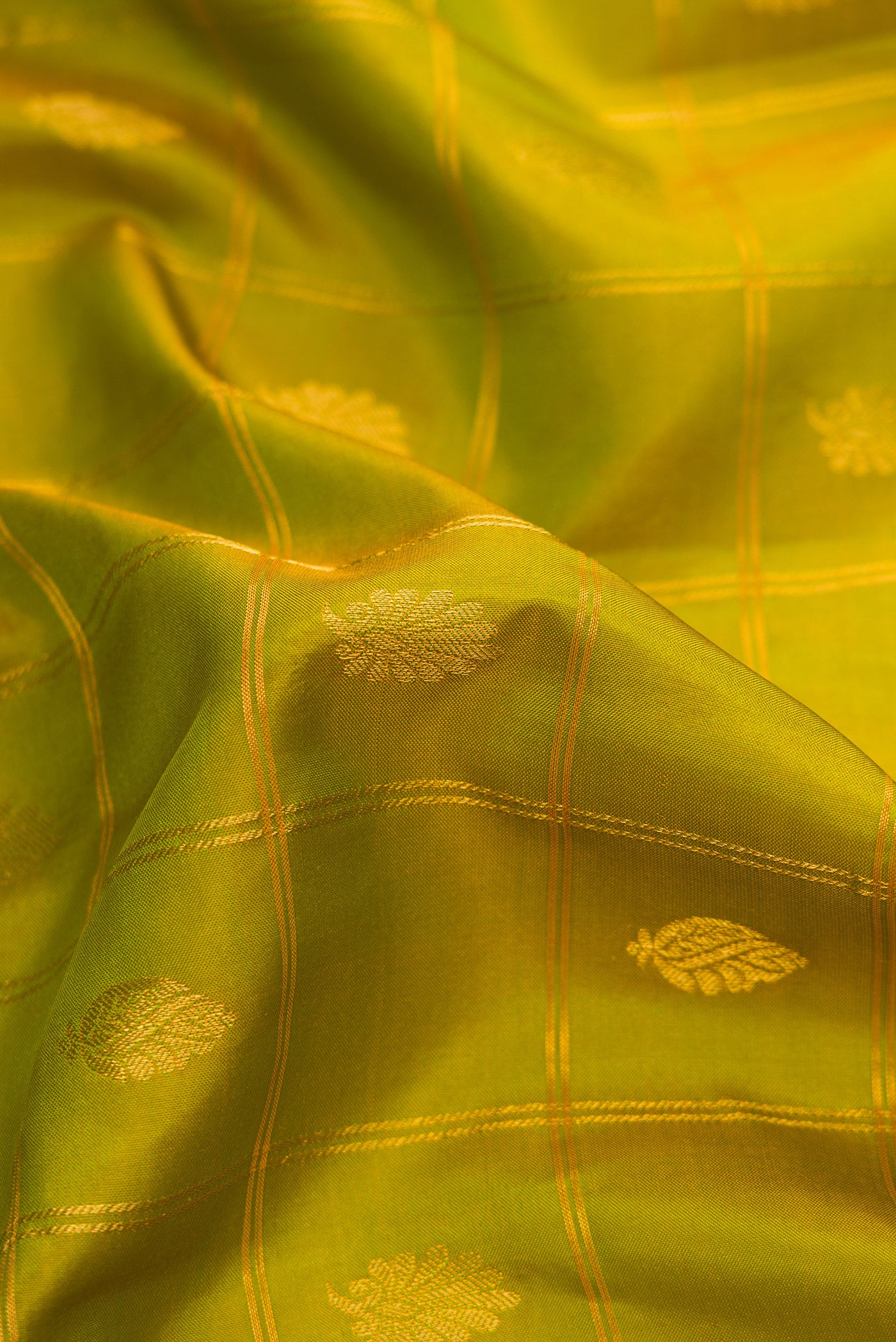 Close up of Parrot Green Dual Tone Gadwal Silk Saree with Checked design on the body and Zari Border.  displaying folds