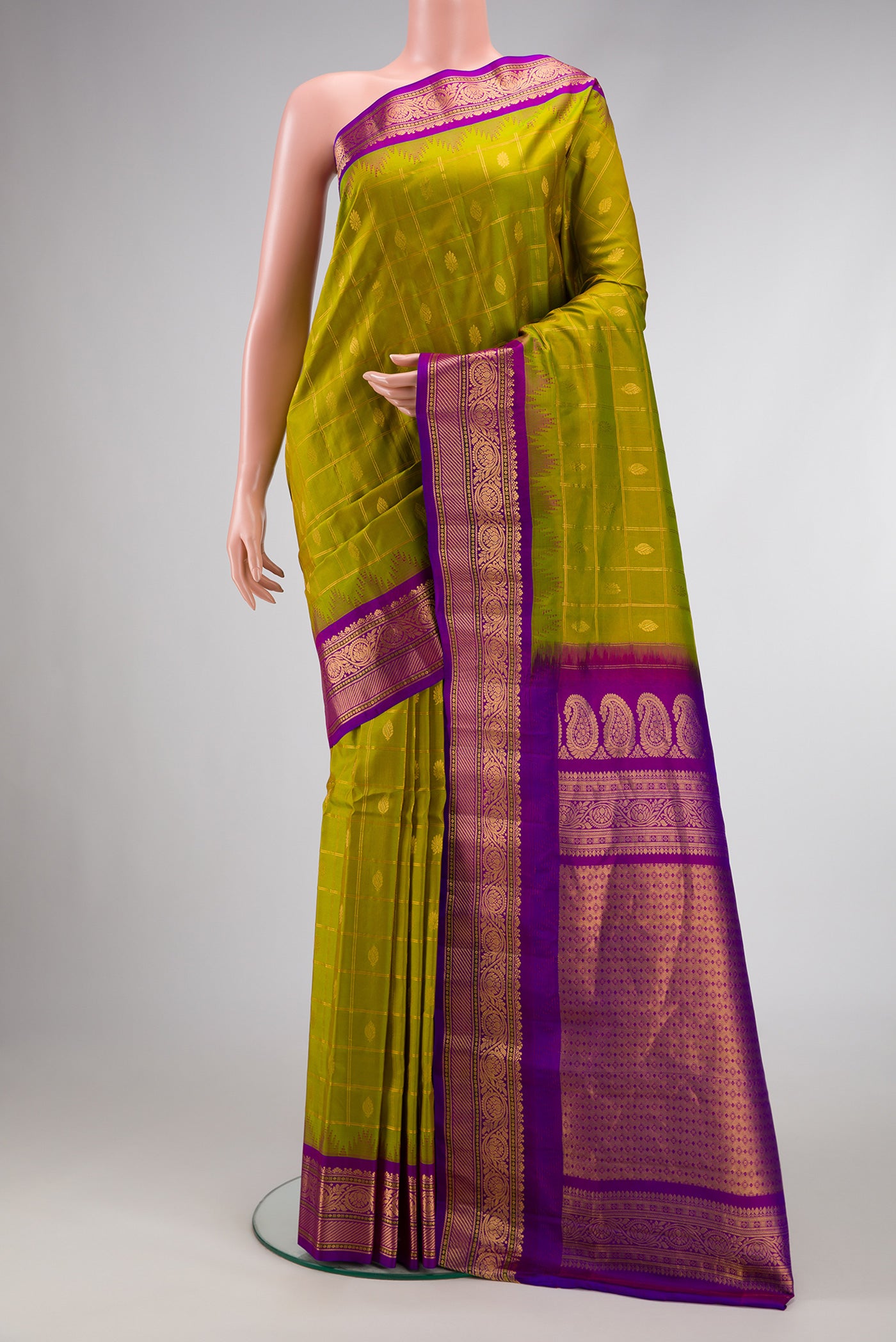 Parrot Green Dual Tone Gadwal Silk Saree with Checked design on the body and Zari Border.  displayed on a mannequin