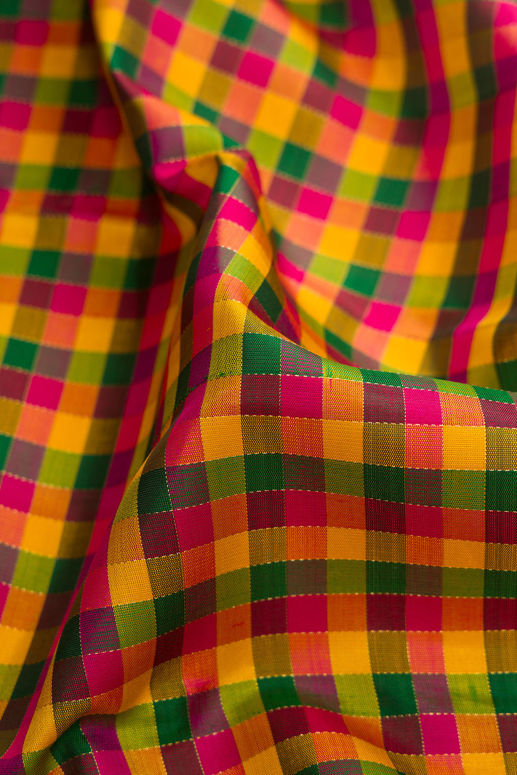 Close up of Pure Silk Pure Zari Yellow, Pink and Green Color Kanjivaram Saree with Checked design on the body and Without Border.  displaying folds