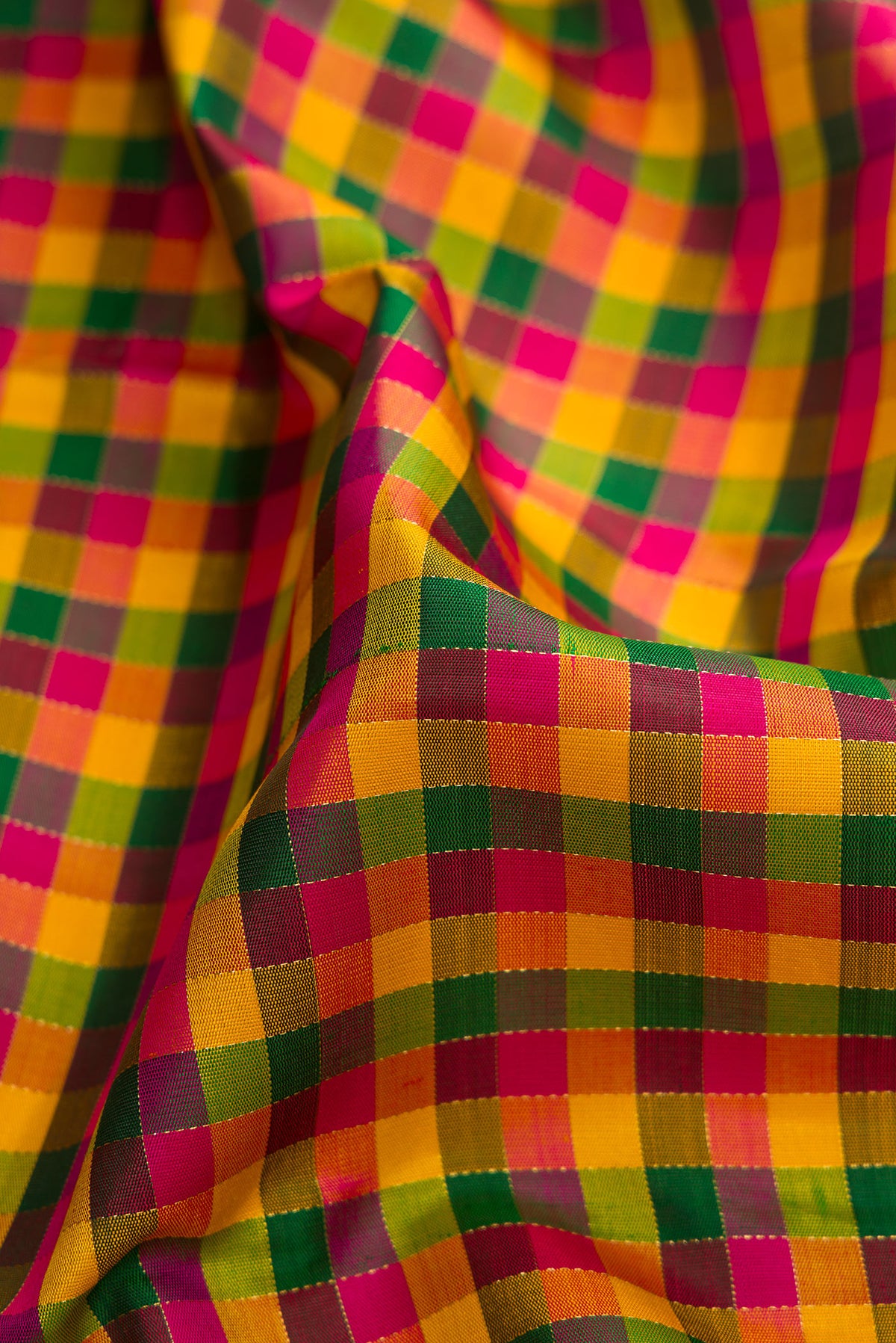 Close up of Pure Silk Pure Zari Yellow, Pink and Green Color Kanjivaram Saree with Checked design on the body and Without Border.  displaying folds