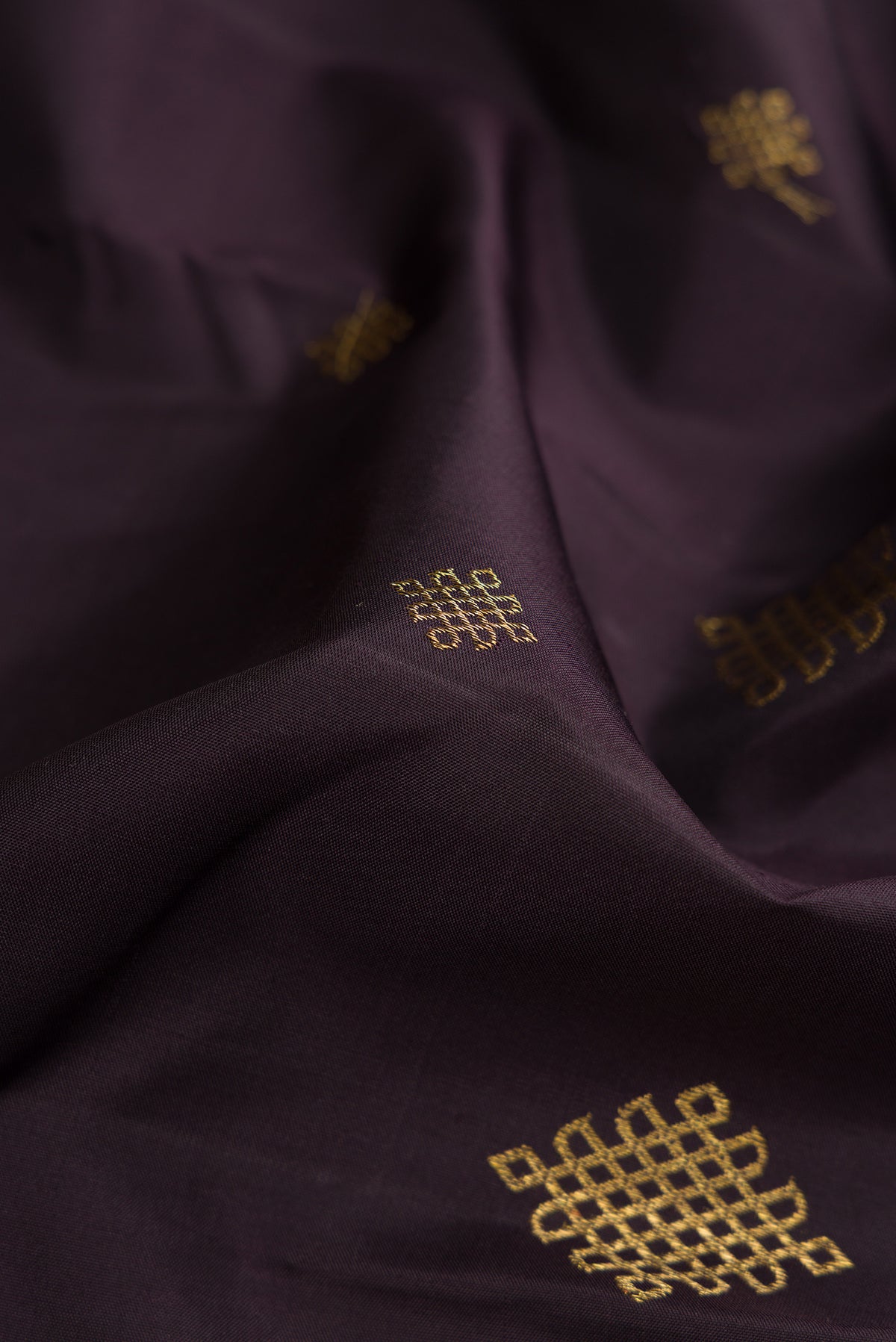 Close up of Pure Silk Pure Zari Coffee Brown Dual Tone Kanjivaram Saree with Zari Butta on the body and Zari Border.  displaying folds