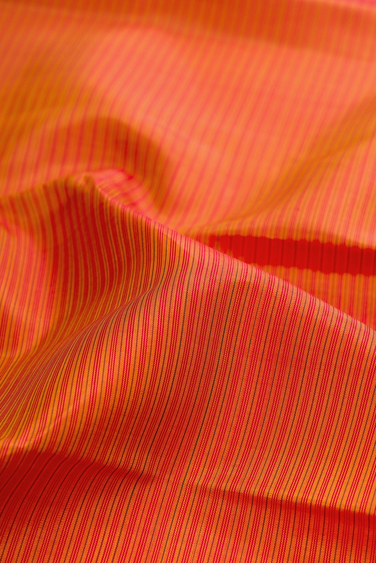 Close up of Pure Silk Pure Zari Mustard Kanjivaram Saree with Stripes on the body and Fancy Border.  displaying folds