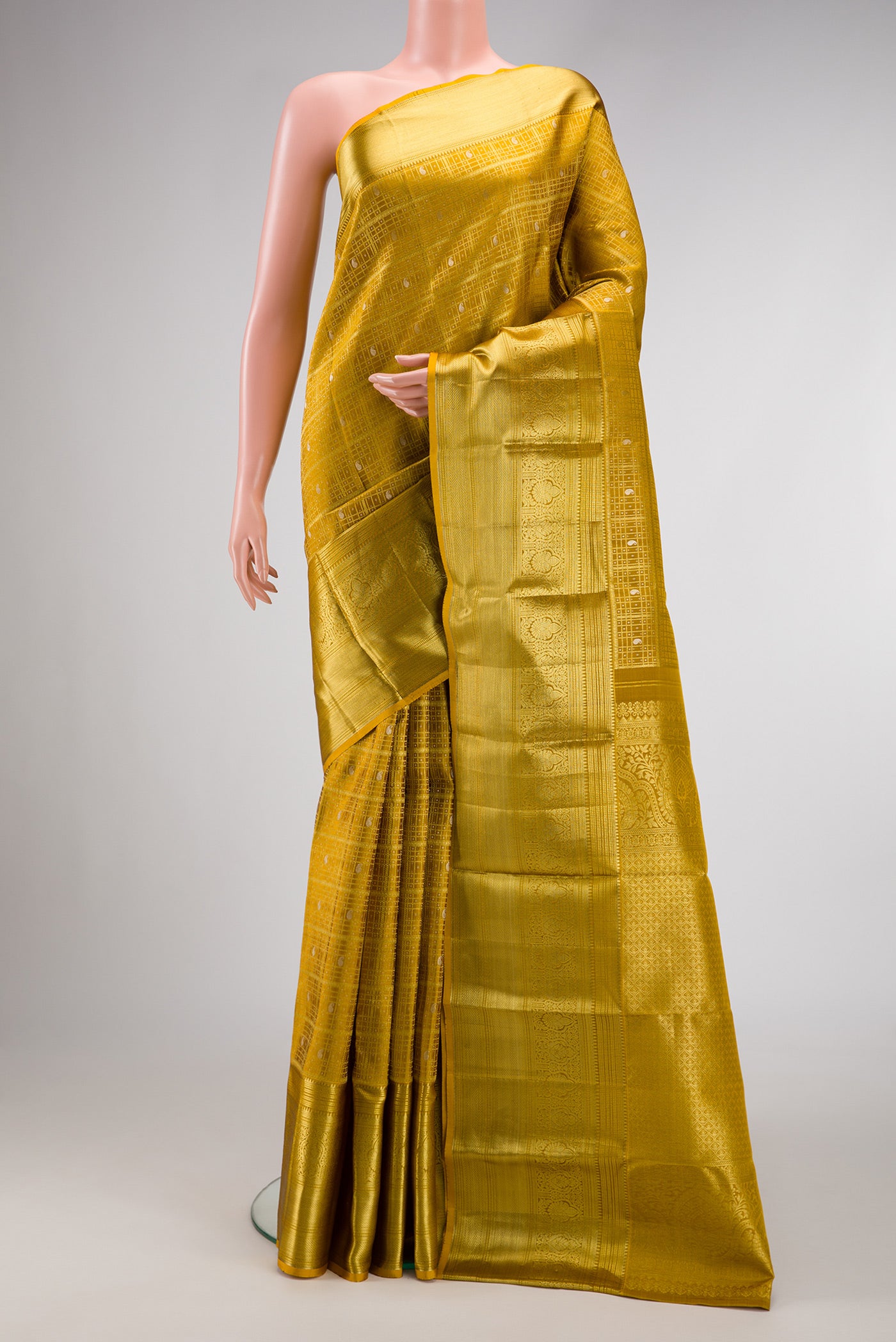 Gold Dual Tone Kanchipuram Silk Saree with Zari Brocade on the body and Zari Border.  displayed on a mannequin