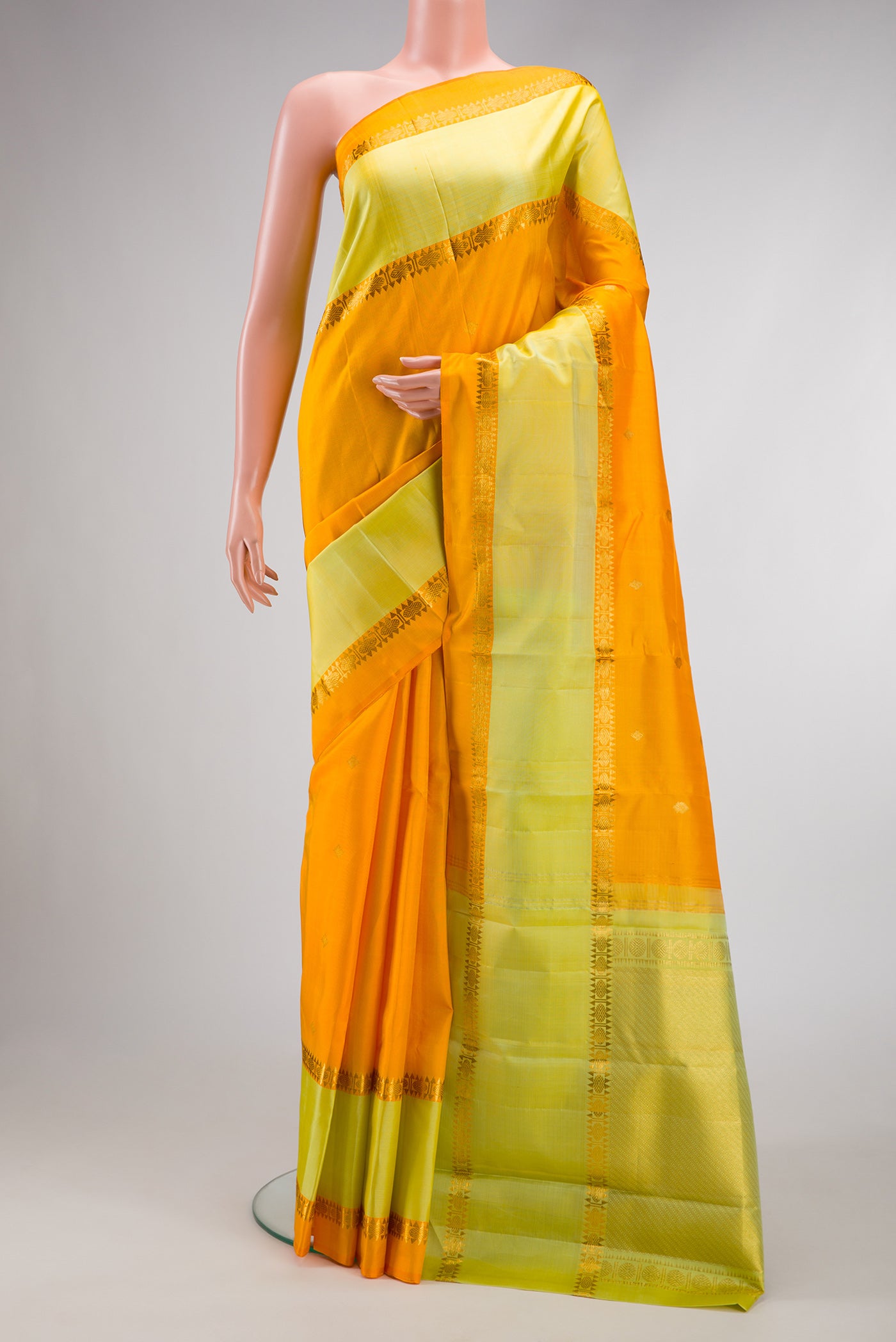 Pure Silk Pure Zari Yellow Dual Tone Kanjivaram Saree with Zari Butta on the body and Zari Border.  displayed on a mannequin