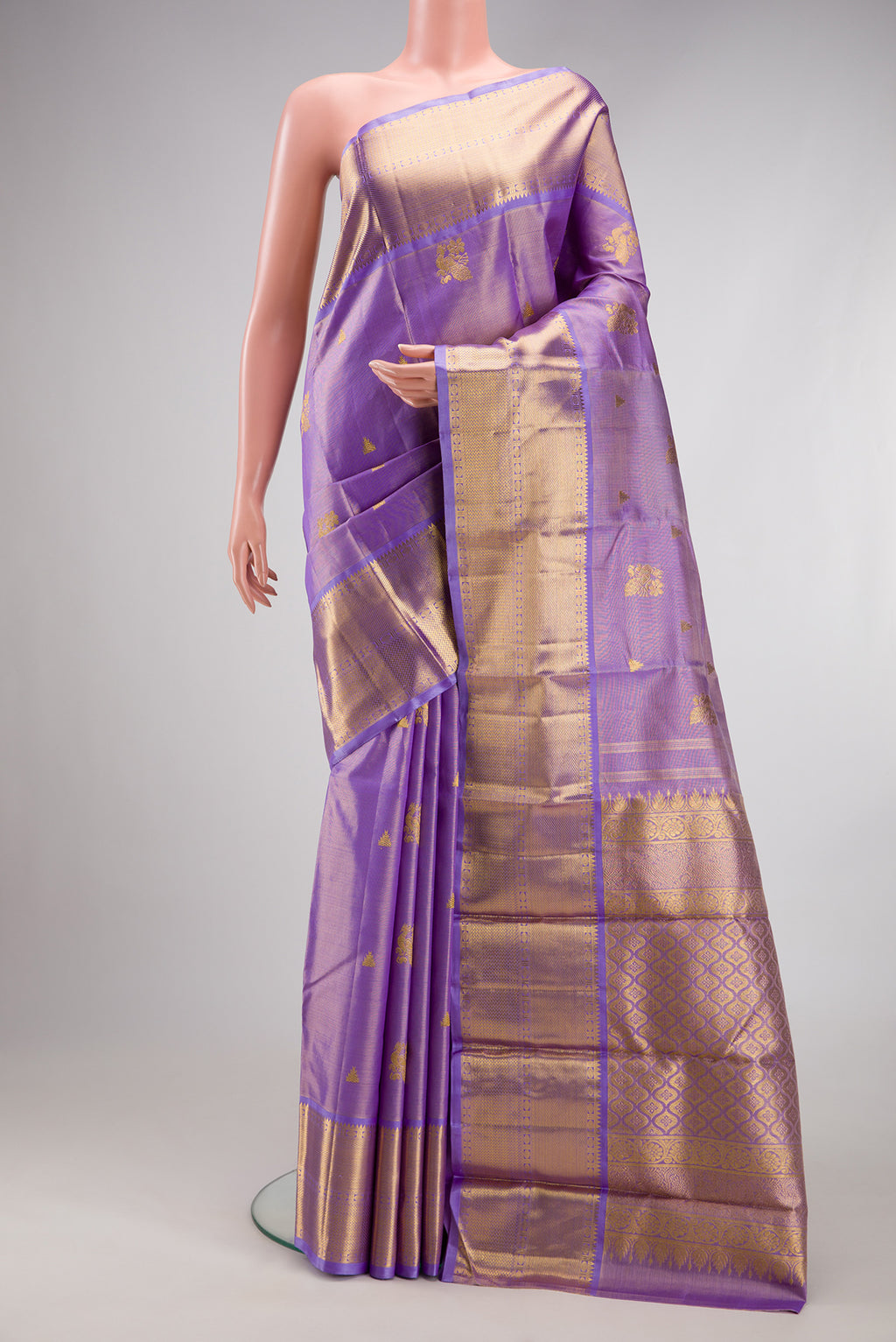 Lavender Kanchipuram Silk Saree with Zari Butta on the body and Fancy Border.  displayed on a mannequin