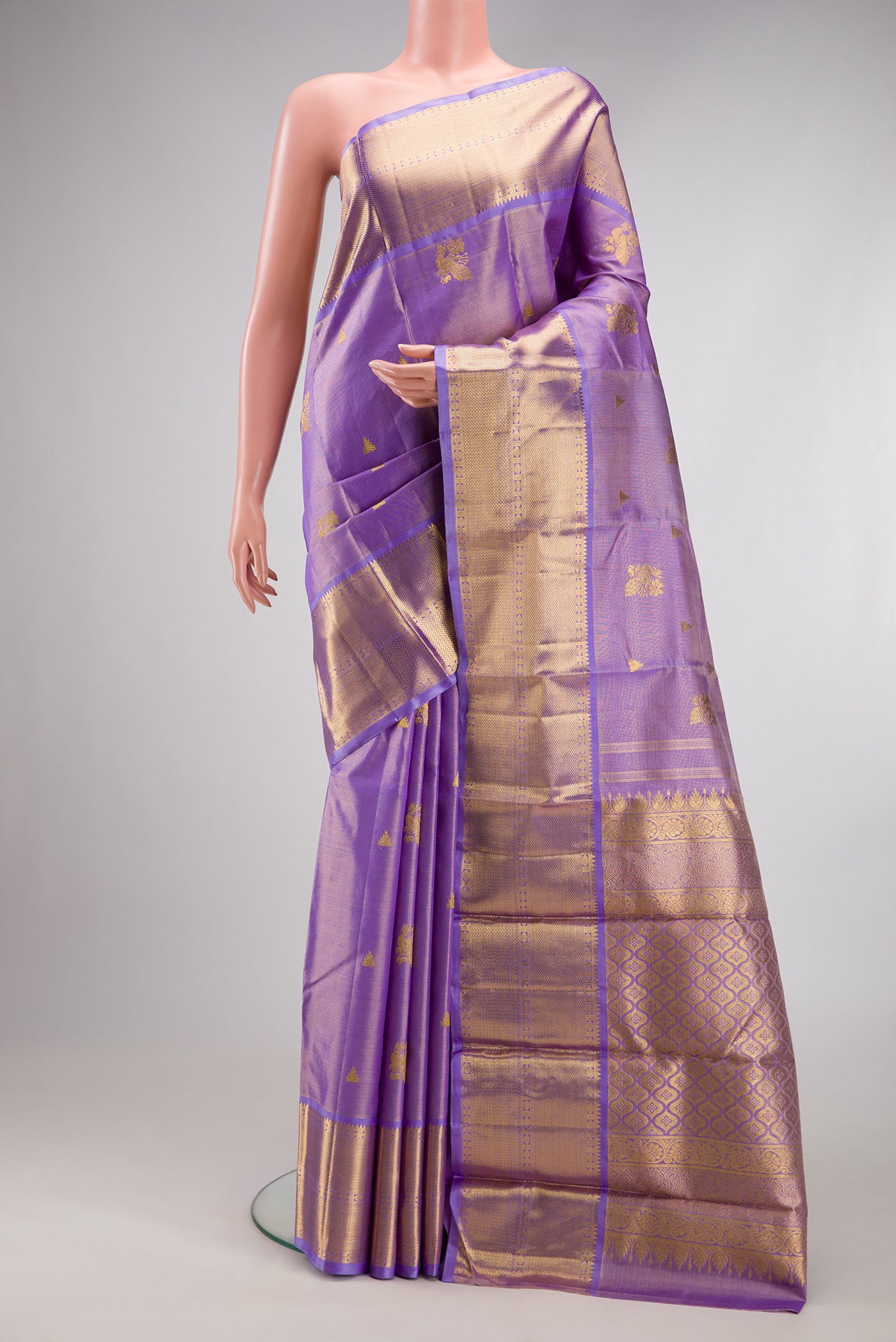 Lavender Kanchipuram Silk Saree with Zari Butta on the body and Fancy Border.  displayed on a mannequin