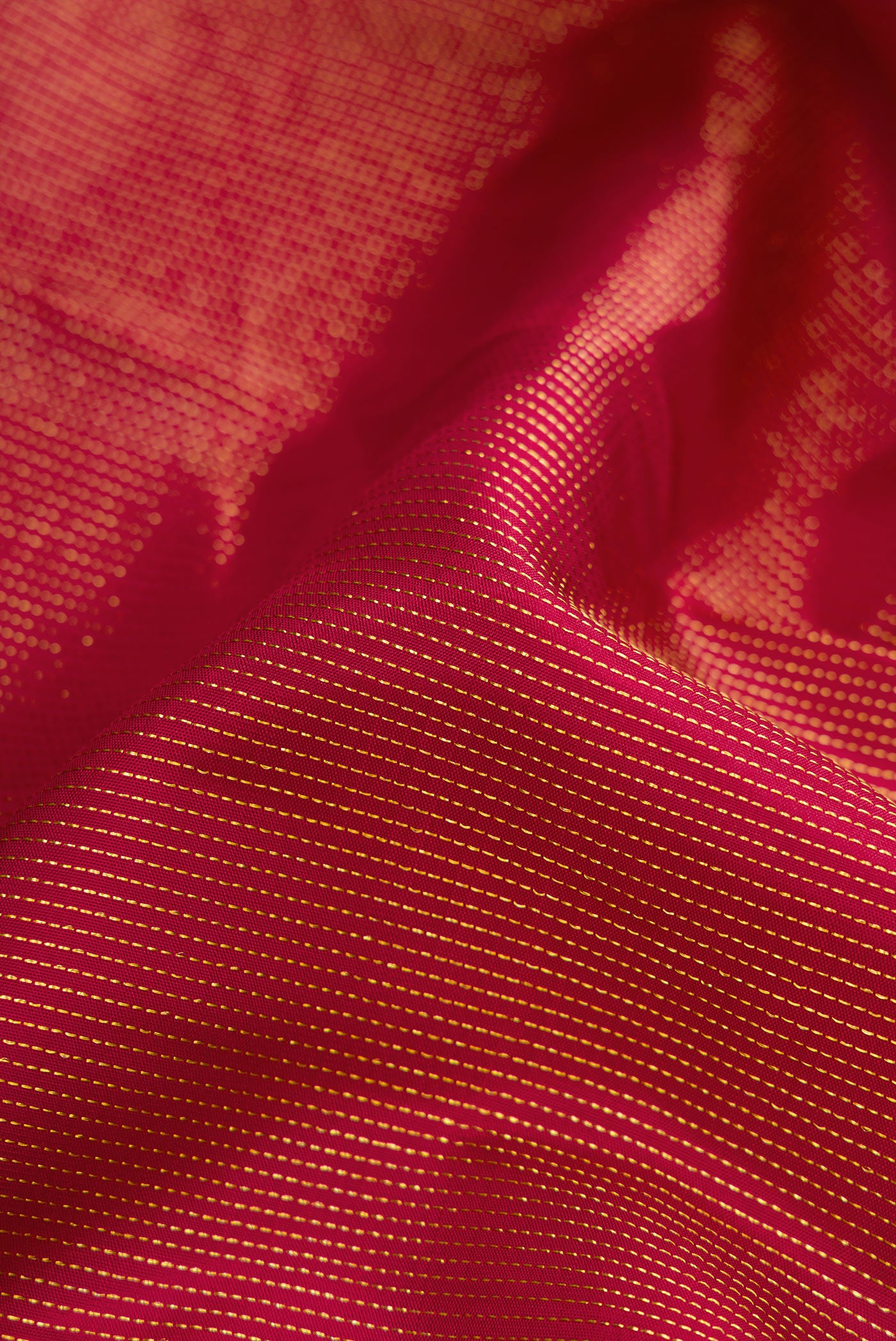 Close up of Pure Silk Pure Zari Magenta Dual Tone Kanjivaram Saree with Zari Brocade on the body and Fancy Border.  displaying folds