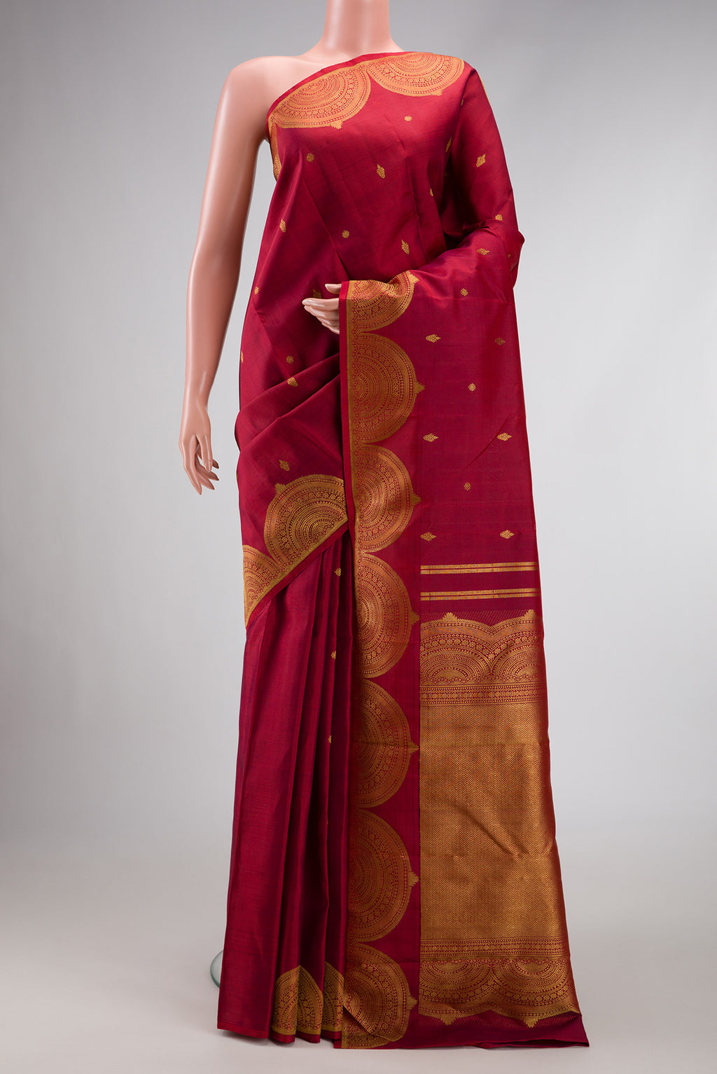 Pure Silk Pure Zari Maroon Dual Tone Kanjivaram Saree with Zari Butta on the body and Fancy Border.  displayed on a mannequin