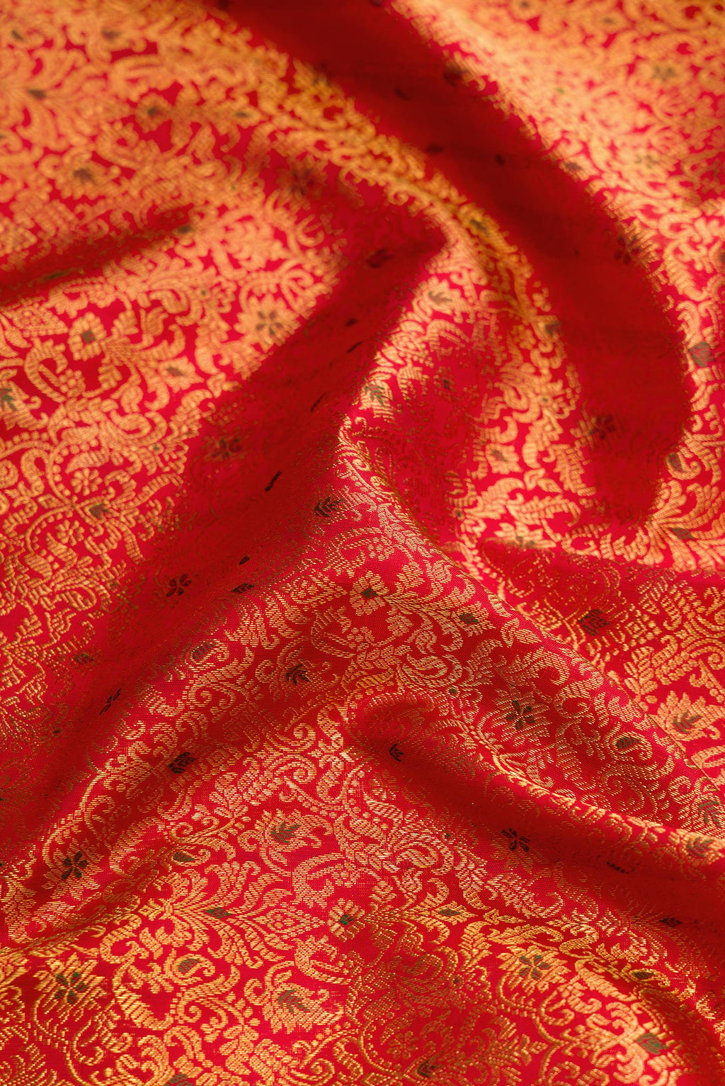 Close up of Red Dual Tone Kanchipuram Silk Saree with Zari Brocade on the body and Zari Border.  displaying folds