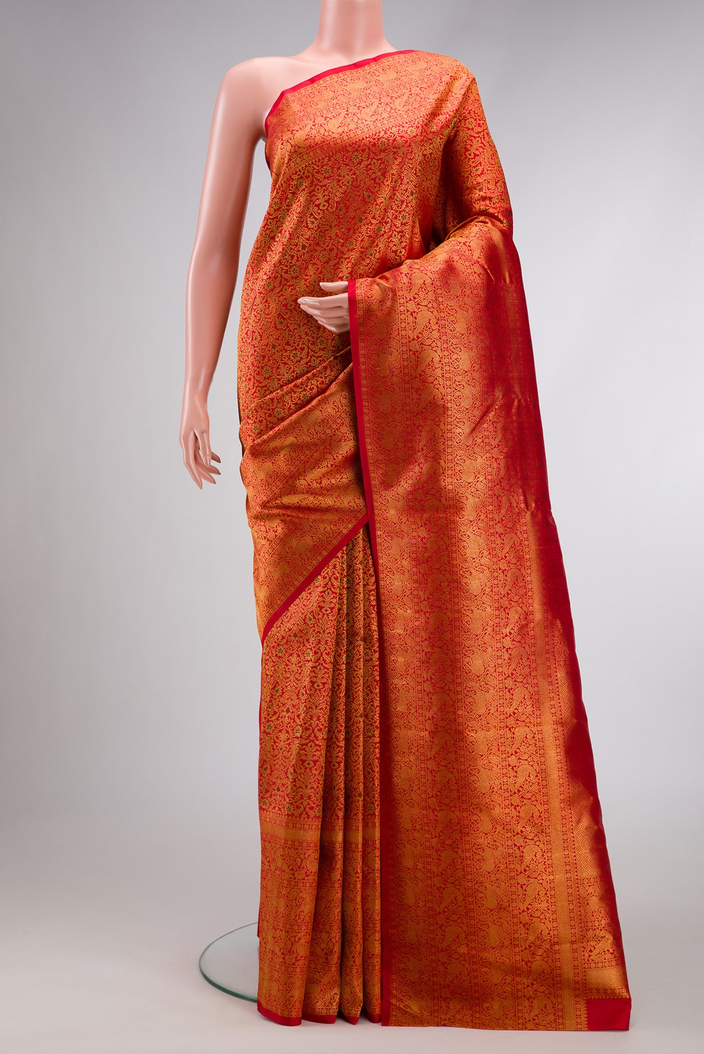 Red Dual Tone Kanchipuram Silk Saree with Zari Brocade on the body and Zari Border.  displayed on a mannequin